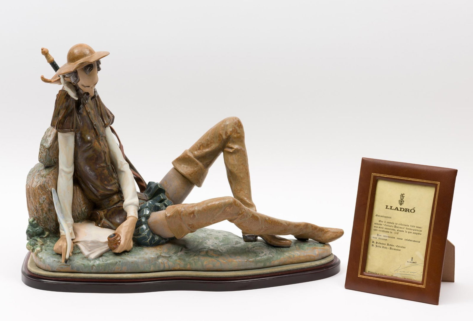 Lladro Letters to Dulcinea Figurine: DESCRIPTION: Lladro Letters to Dulcinea figurine. Depicts Don Quixote writing a letter. Signed on the back. With signed certificate and stand. MEASUREMENTS: 8-3/4" wide x 19-3/4" long x 15-1/4" high. 