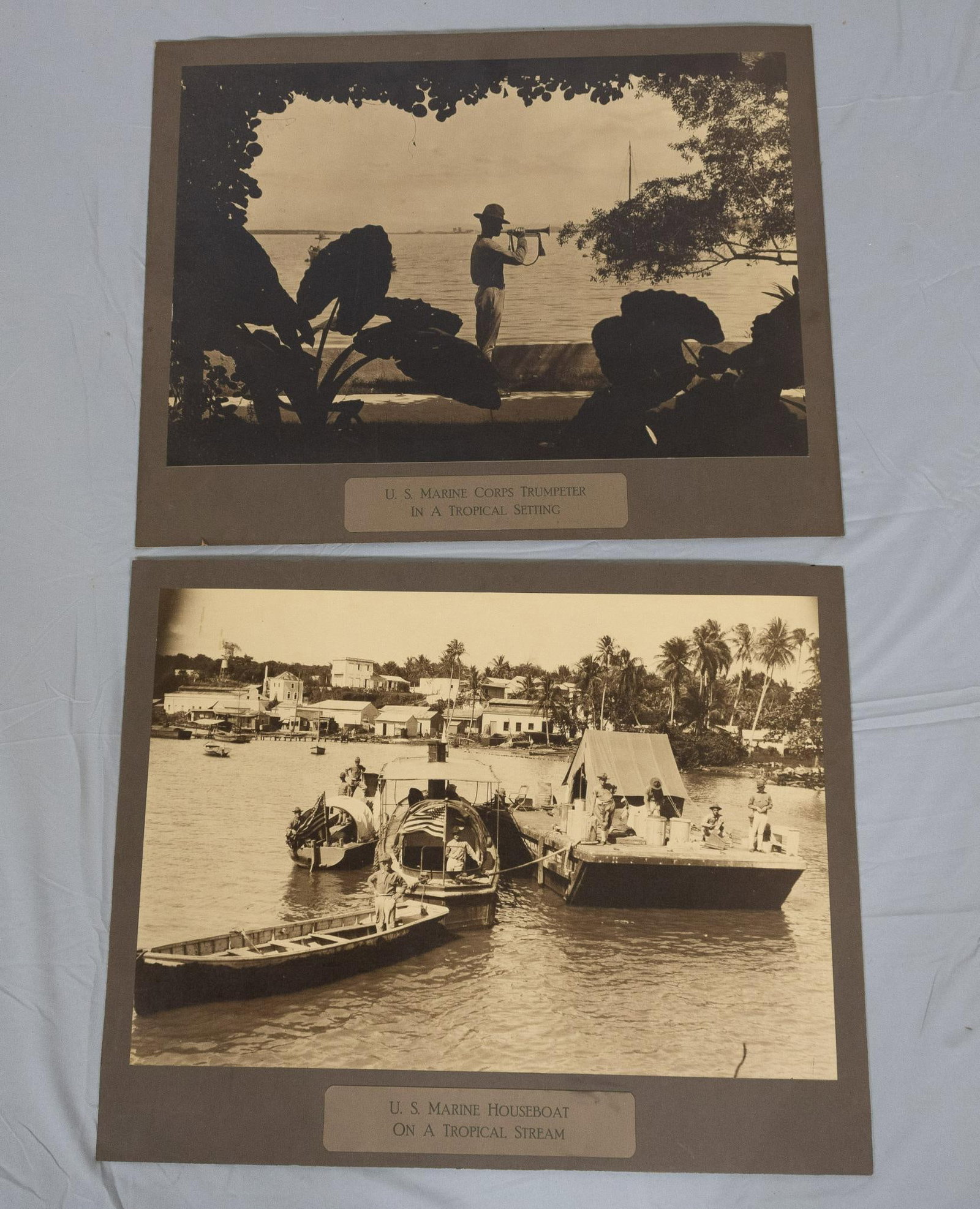 2 Pre-WWII Photographs Of US Marines: 2 photographs of US Marines deployed to an unnamed tropical location (possibly Philippines). Likely pre-WWII, with flag shown having 48 stars. Total dimensions 20" high x 25" wide. Light wear. PROVENA