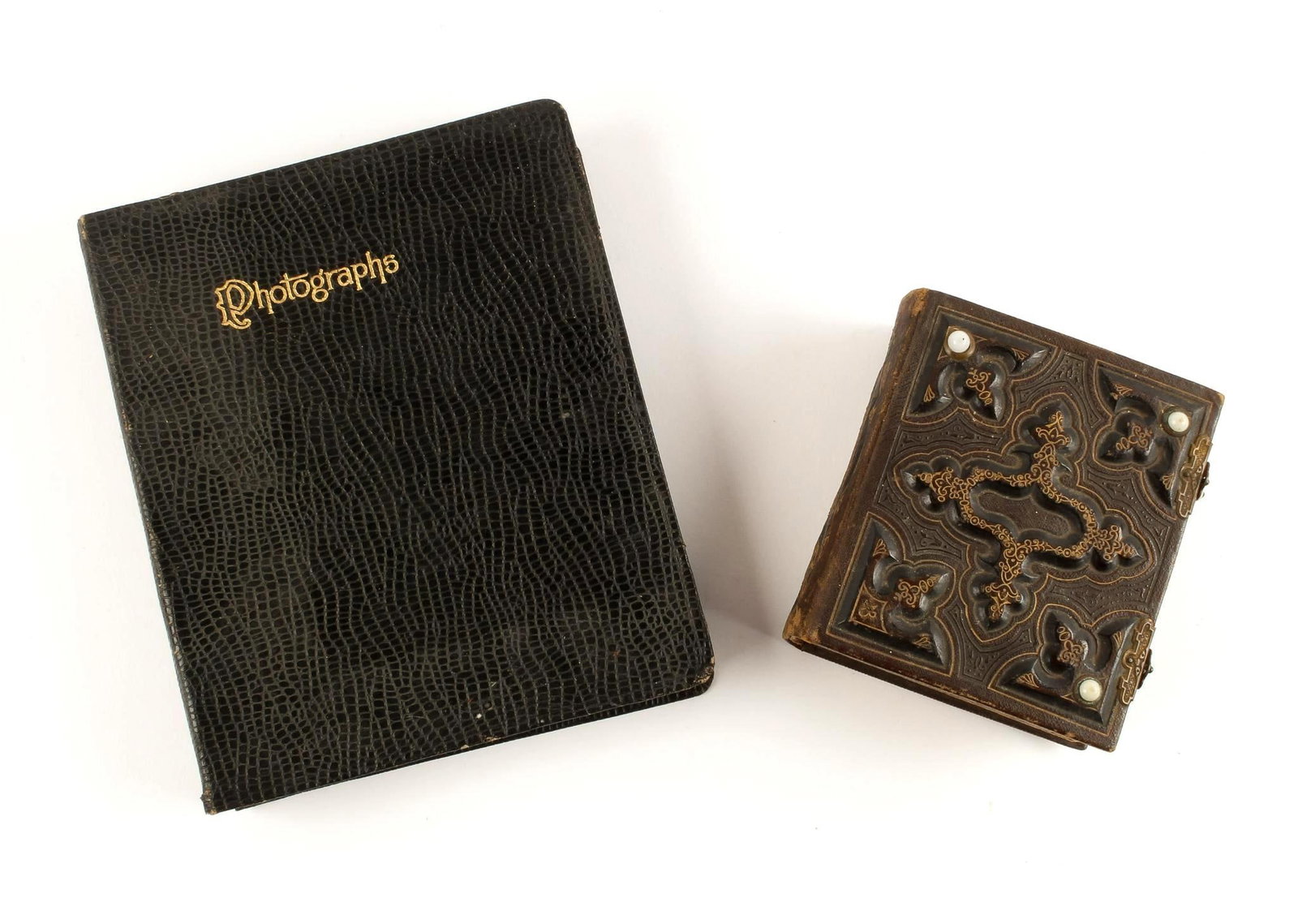 2 Antique Photo Albums: Photo album one has 51 photos, photo album two has 10 photos. Photos seem to be from civil war era. Photo album one has black snake skin cover with black pages. Photo album two has gilt edged pages an