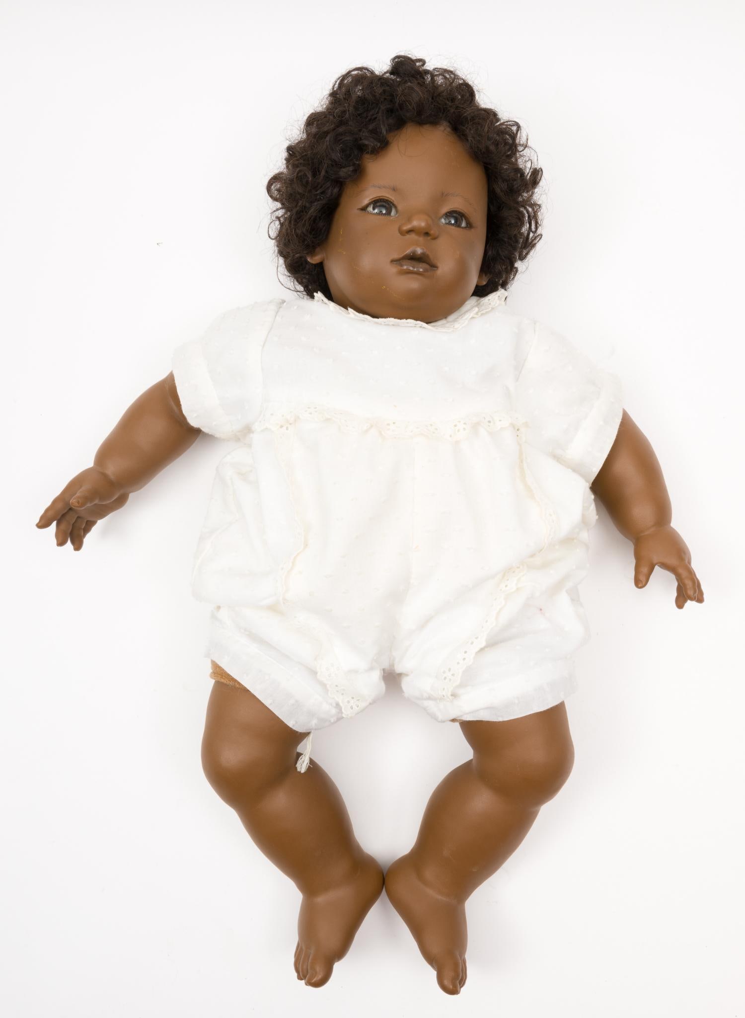 Annette Himstedt "Mo" Doll: Hard vinyl flange head, human hair wig, stationary glass eyes with eyelashes, on loosely filled cloth body with vinyl arms and legs. 22" long. No condition issues. MEG