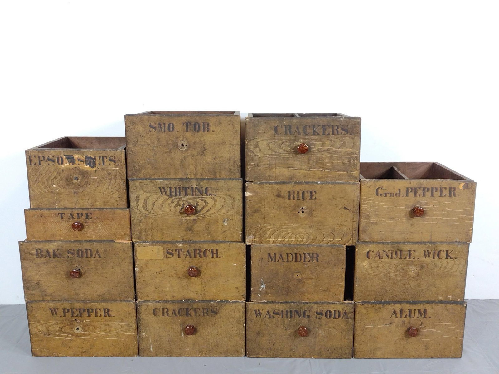 15 Apothecary Drawers: 13" to 16" wide X 15-1/4" deep X 5" to 8-1/2" high. Some missing drawer pulls. All have discoloring. MG.