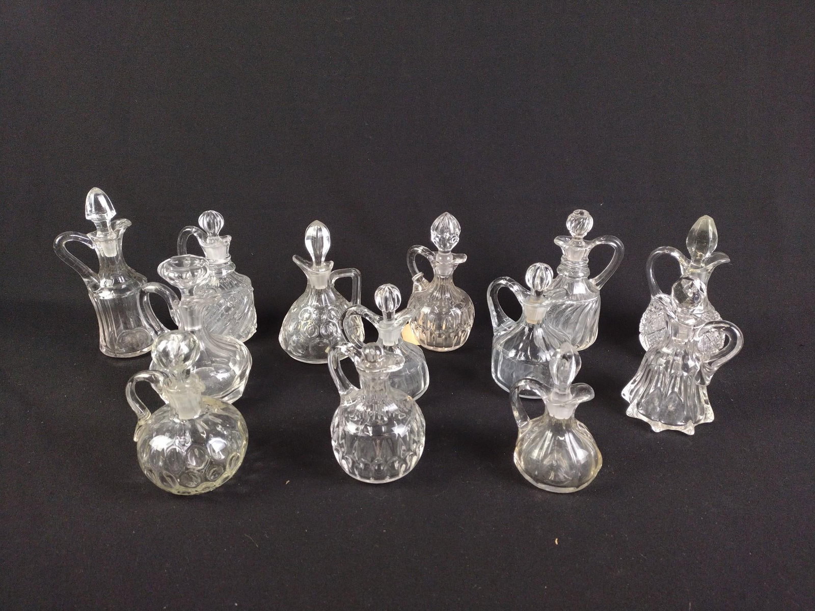 28 Antique Glass Cruets: 4-1/2" to 6-1/2" high. Some losses consistent with age and use. 4 without stoppers.