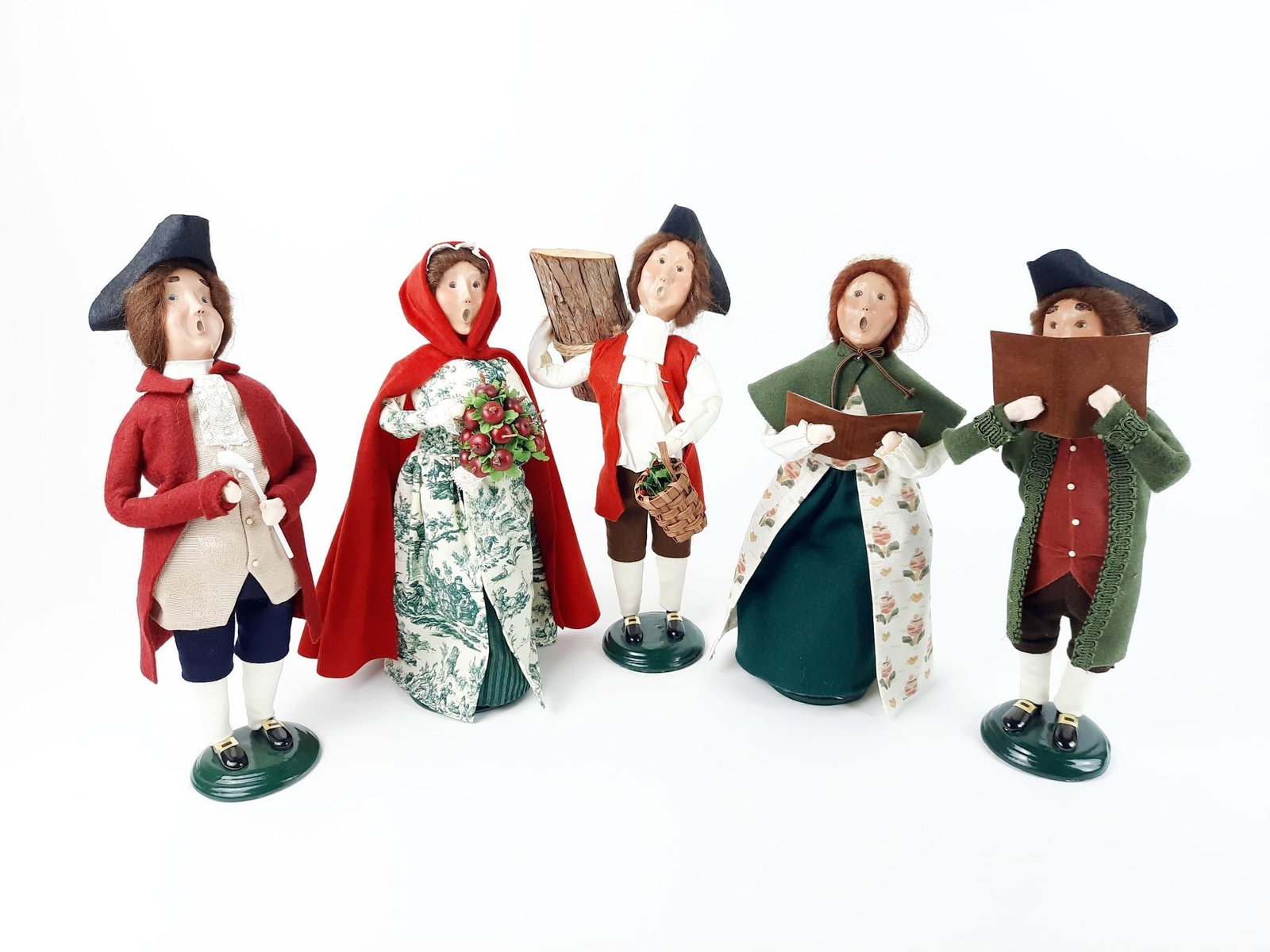 5 Williamsburg Byers Choice Carolers: 13" to 14" high. Female singer with sheet music detached. Minor loss to green paint on bases.