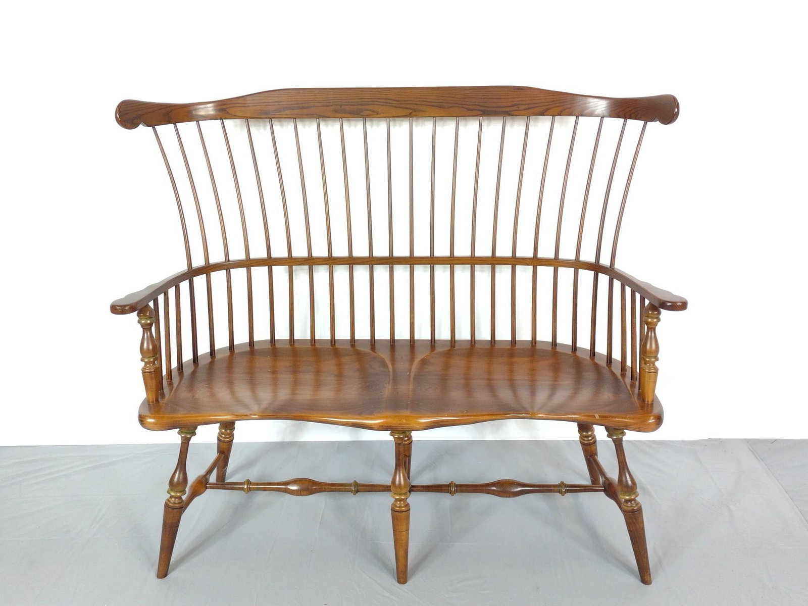 Colonial Reproductions Comb-Back Settee: 50-1/4" wide X 18" deep X 44" high. Has a few light scratches. MG.
