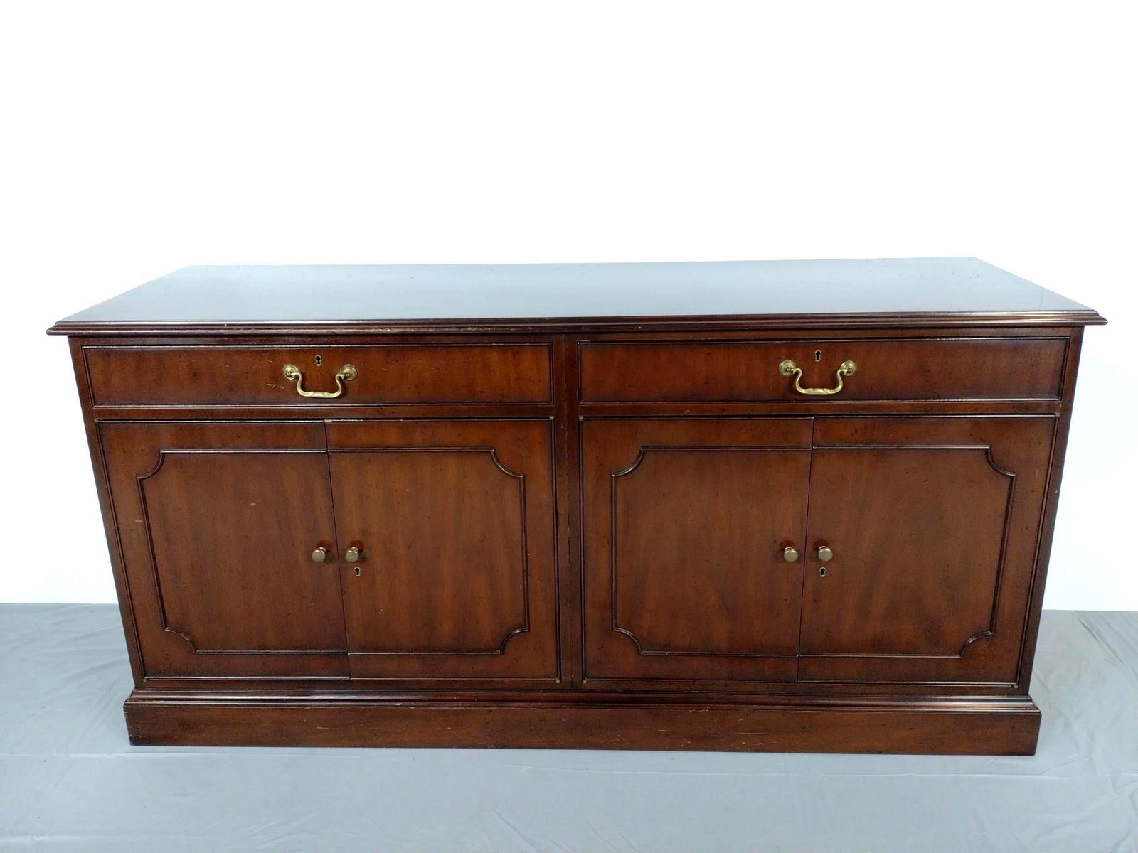 Kittinger Credenza: 61" wide x 20" deep x 30-1/2" high. Scratches throughout wood surface.