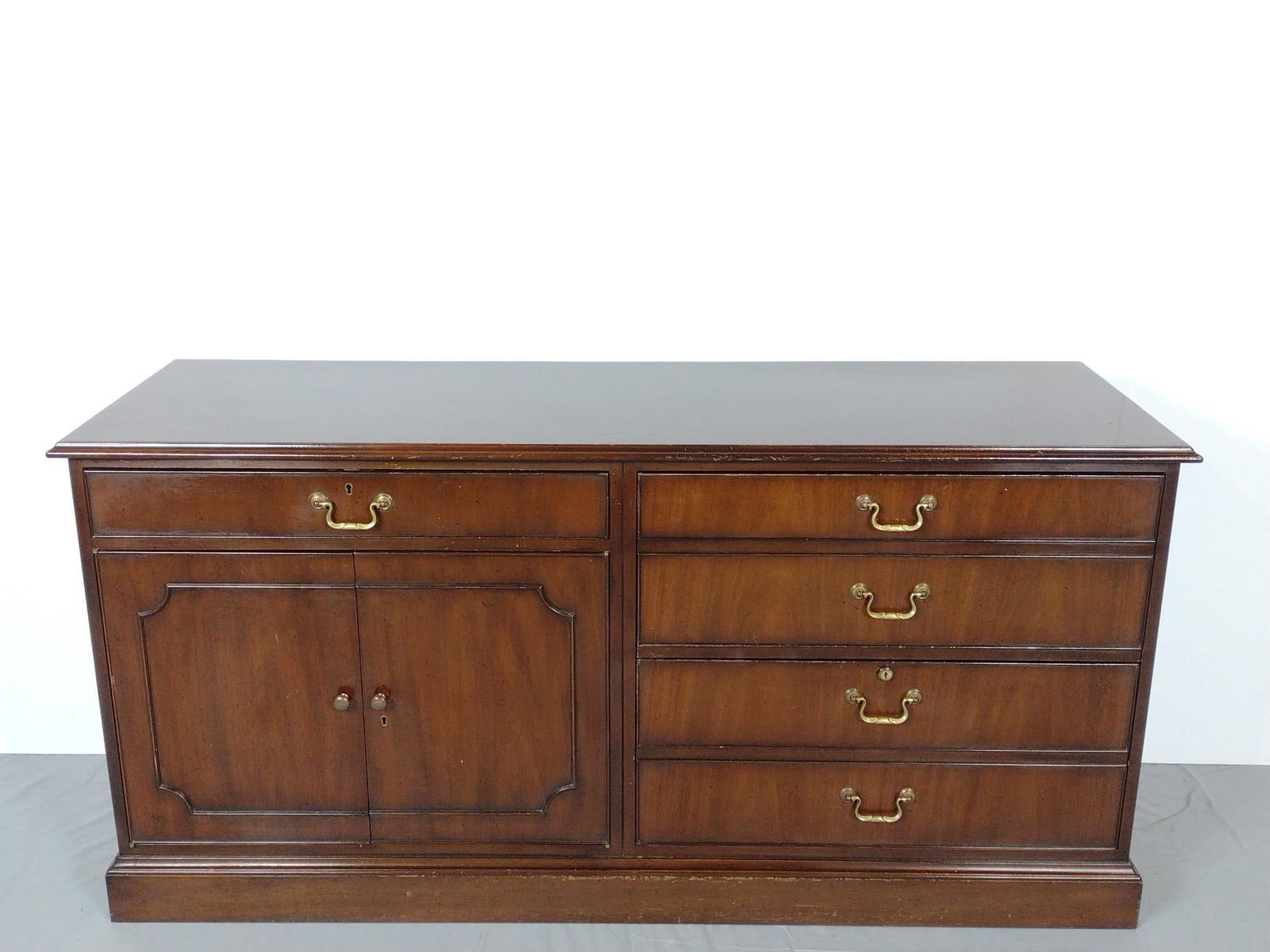 Kittinger Credenza: 61" wide x 20" deep x 30-1/2" high. Scratches throughout wood surface.