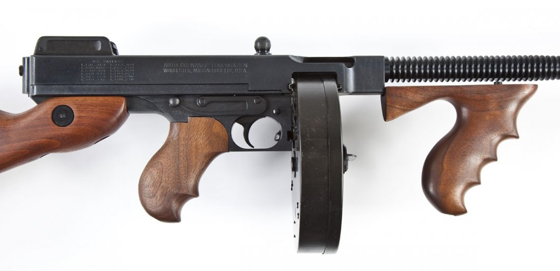 Auto Ordinance Model of 1927 A1 Carbine - .45 Acp: SERIAL #: KH7651 DESIGN: Semi automatic with detachable magazine. 16-1/2" finned barrel with compensator. MATERIAL/FINISH COMPOSITION: Blued steel. Walnut stock, pistol grip, and forearm grip. Curved 
