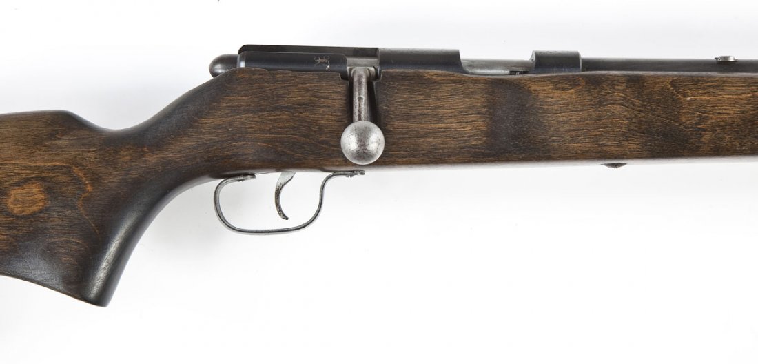 Marlin Model 81 Rifle - .22 LR: SERIAL #: None DESIGN: Bolt action with tubular magazine. 24" barrel. MATERIAL/FINISH COMPOSITION: Blued steel. Wood pistol grip stock. Black plastic butt plate. FEATURES: Blade front sight. Stock has