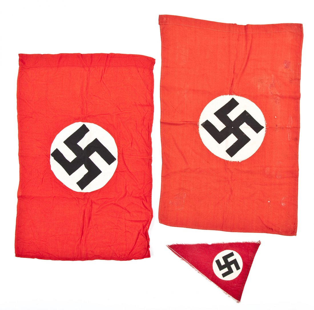 Group of 3 Nazi World War II Small Flags: DESCRIPTION: A group of three small German World War II flags consisting of two similar sized NSDAP small flags and a NSDAP triangular car pennant. MEASUREMENTS: Ranging in size from 9" x 6-3/4" to 22