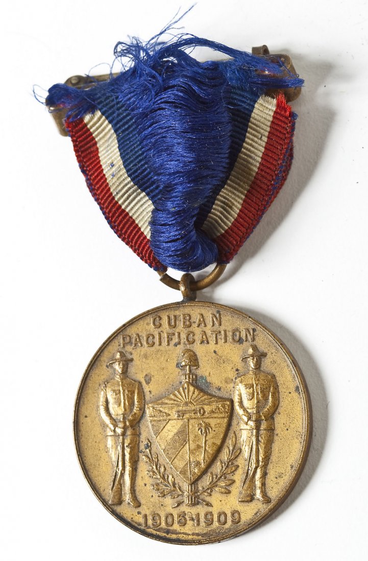 US Army Cuban Pacification Medal for Service: DESCRIPTION: Cuban pacification medal marked with years of US occupation,1906-1909. Bottom edge marked No 5073, denoting it was presented to a member of the service. MEASUREMENTS: 1-1/4" diameter. CON