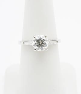 Platinum & 1.82 CTW Diamond Engagement Ring: Platinum (stamped) setting with center 1.56 carat round brilliant cut diamond accented by two .13 carat each tapered baguette cut diamonds. Main stone Clarity SI2, Color J-K (appraisal), N (GIA report