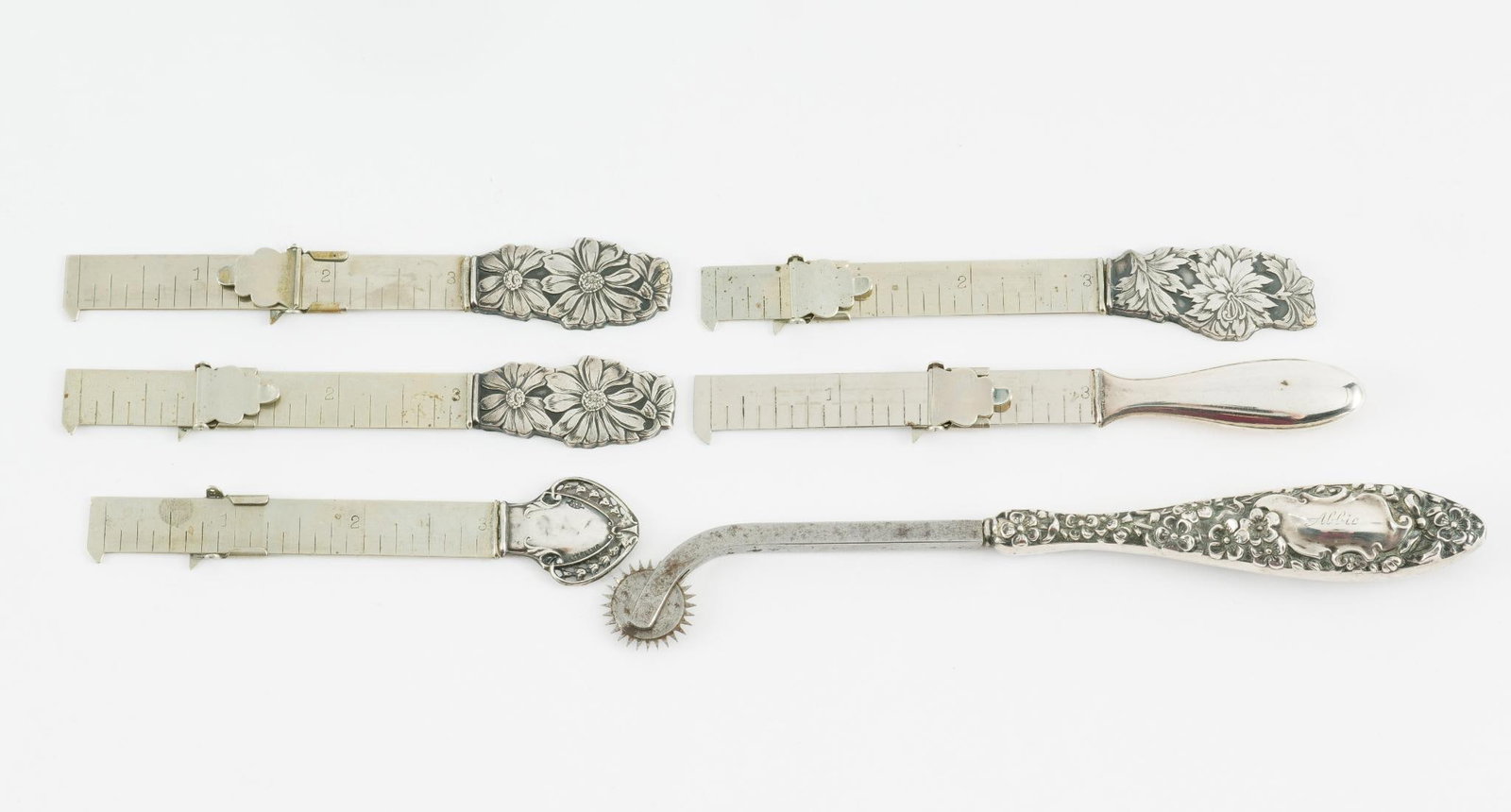 5 Victorian Sterling Hem Measures and Tracing Wheel: Includes sterling handled hem measures and sterling handled tracing wheel. 4-1/4" to 6-1/2" overall. JS