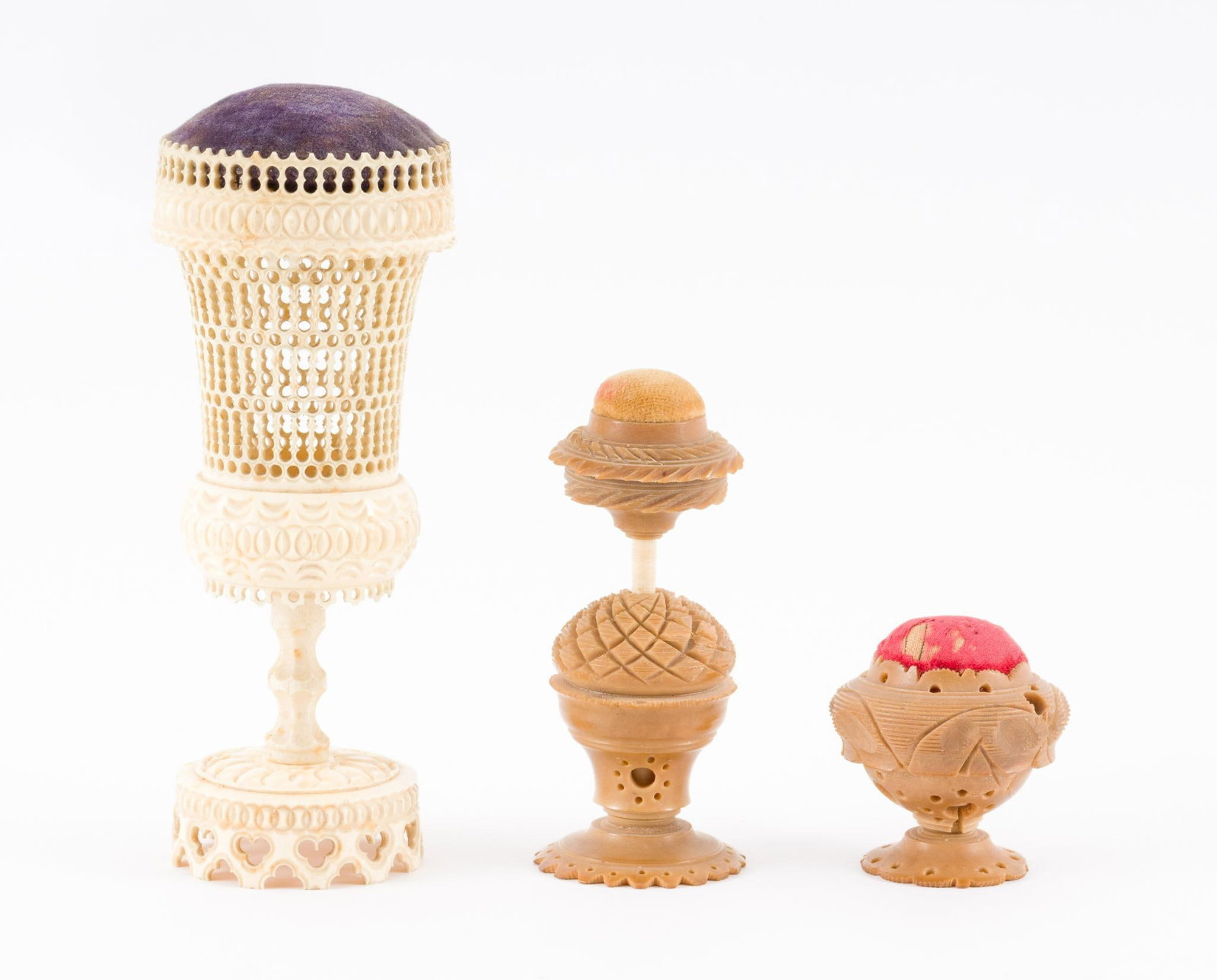 3 Antique Carved Pin Cushions: 2 carved vegetable ivory and one nineteenth century ornately carved bone (craved to top rim). 1-3/4" to 5-1/2" high. JS