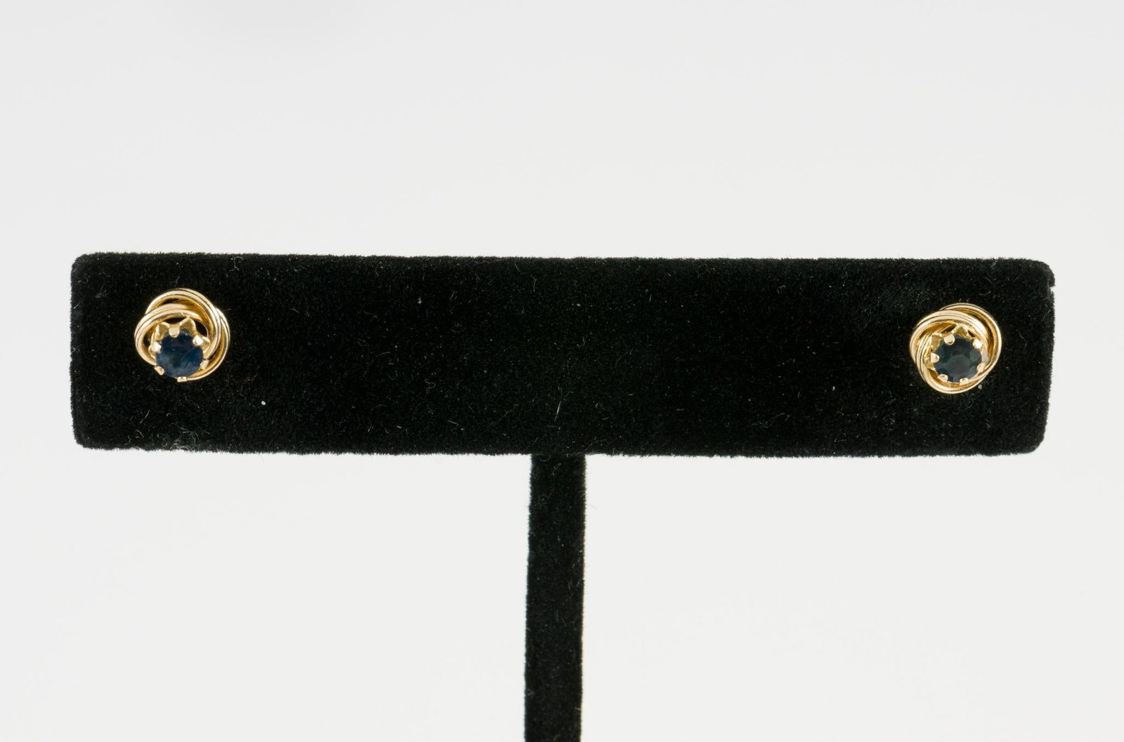 14K Gold & Blue Sapphire Stud Earrings: Marked 14k yellow gold pierced earrings each with round blue sapphire. 0.6 gram. Includes gift box.