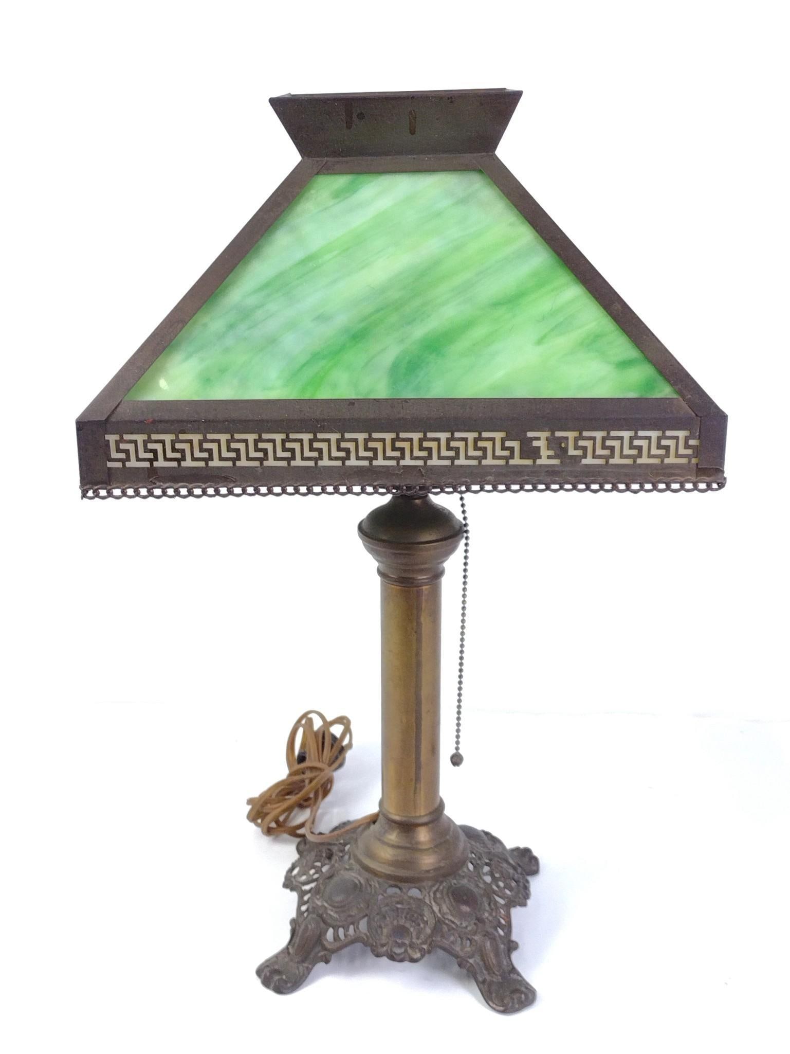 Arts and Crafts Green Glass Lamp: Working. 12-1/4" wide x 12-1/4" deep x 21" high. Glass with black scratches. Lamp base and frame with discoloration consistent with age and use.