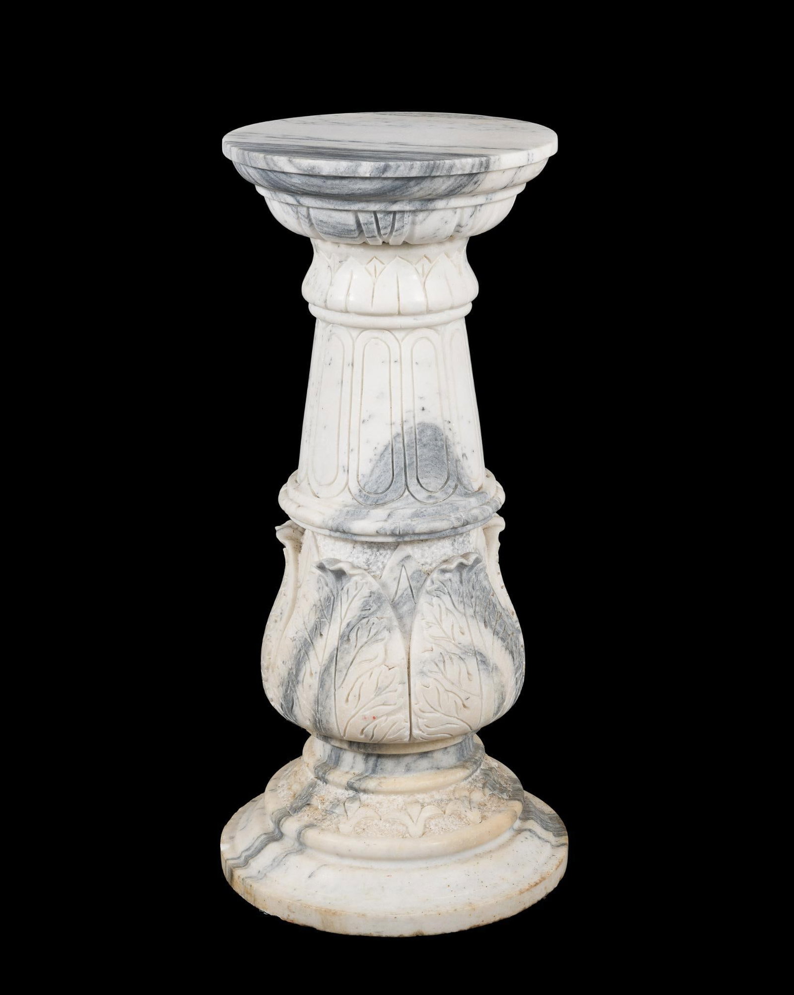 Marble Pedestal: Veined marble pedestal in a neoclassical style with carved leaves. Removable top. Height 35-1/2", top 15" diameter, base 17" diameter. Small repair to top piece. MEG