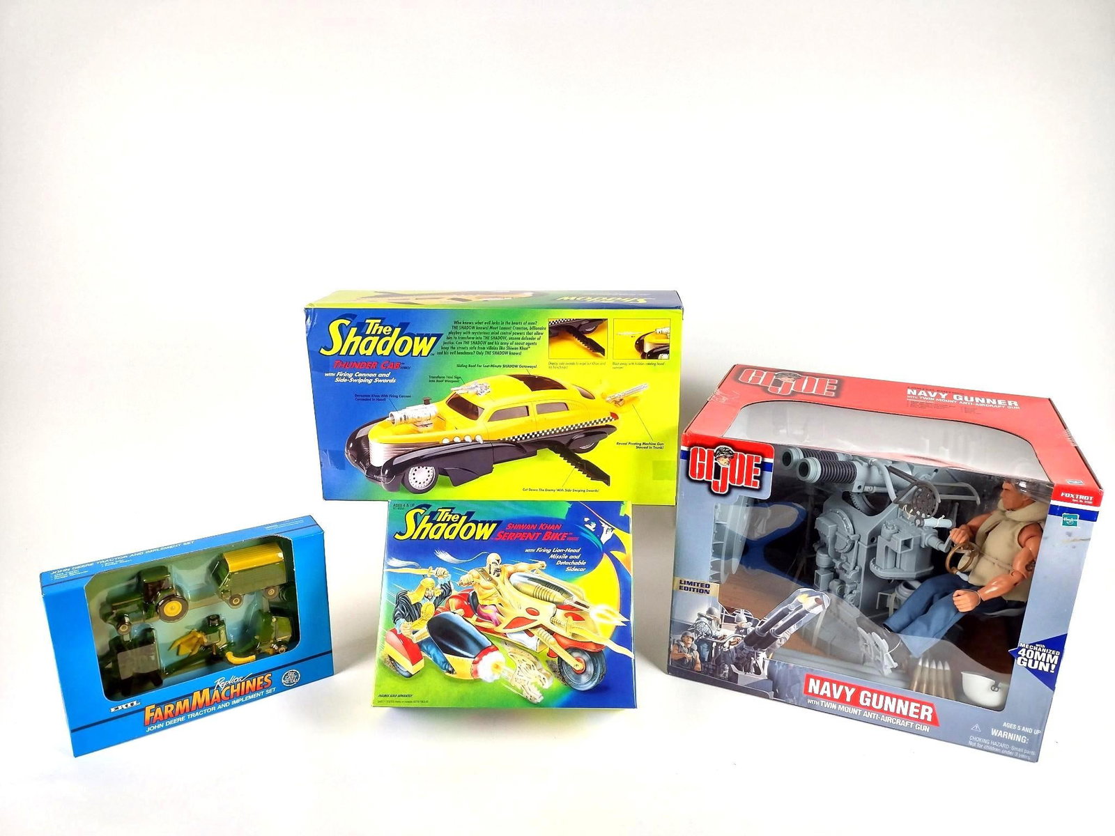 4 Vintage Toys incl G.I. Joe and The Shadow: Includes G.I. Joe "The Gunner", Ertl Farm Machines, The Shadow Shiwan Khan Serpent Bike, and The Shadow Thunder Cab. All appear to be new in box.