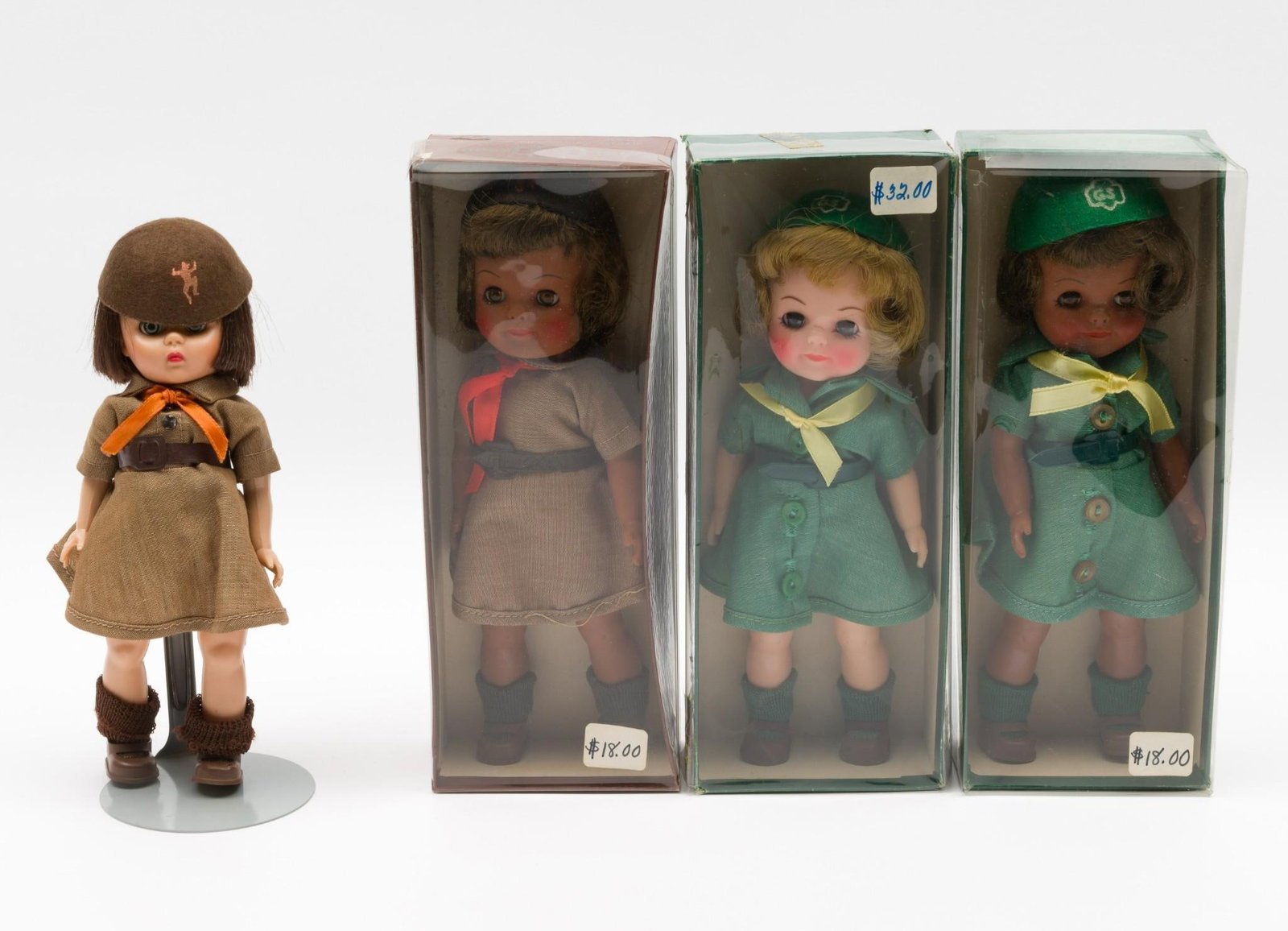 4 Girl Scout Dolls: Four Girl Scout Dolls, three in original boxes. Includes two Girl Scout Brownie Dolls and two Girl Scout Junior Dolls. Dolls measure 7-3/4" long. Boxes measure 3-1/2" wide x 9" deep x 2-1/4" high. Con
