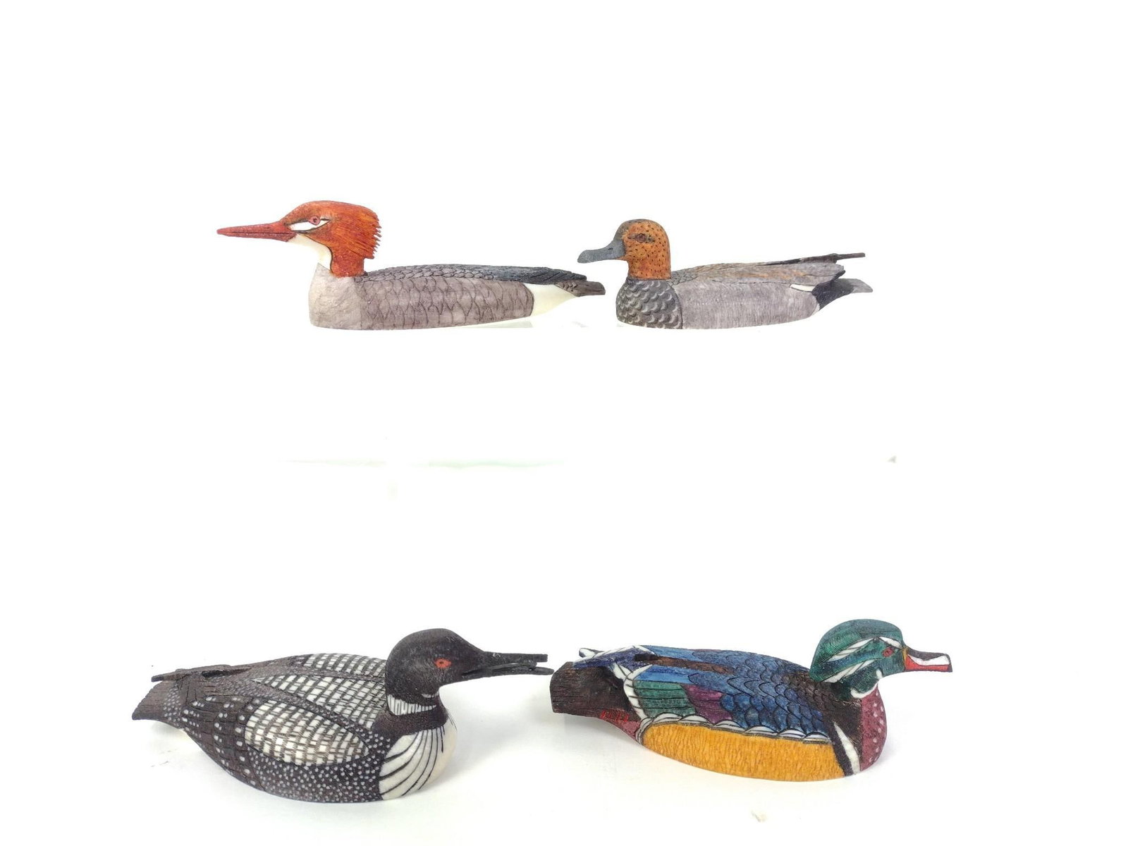 Ted Mayac Jr. Set of Four Carved Water Birds Inuit Walrus Tusk: Carved scrimshaw waterfowl including female Red-breasted Merganser, Gadwall, Wood Duck, and Common Loon Holding Chick. All signed with dates ranging from 2003 to 2007. Lengths of 4" to 4 1/2". LJ