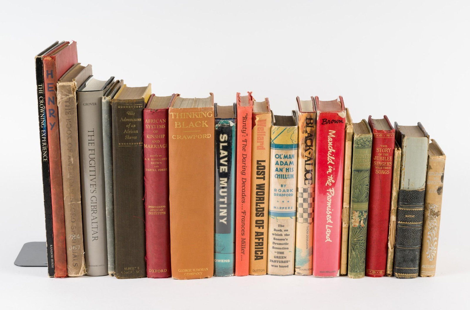 20 African American Studies Books: Includes Book of American Spirituals, Blackface, Cartoons, and Slavery books. All in good condition with some experiencing more loss to spines than others. CONDITION: Due to being in storage for a num