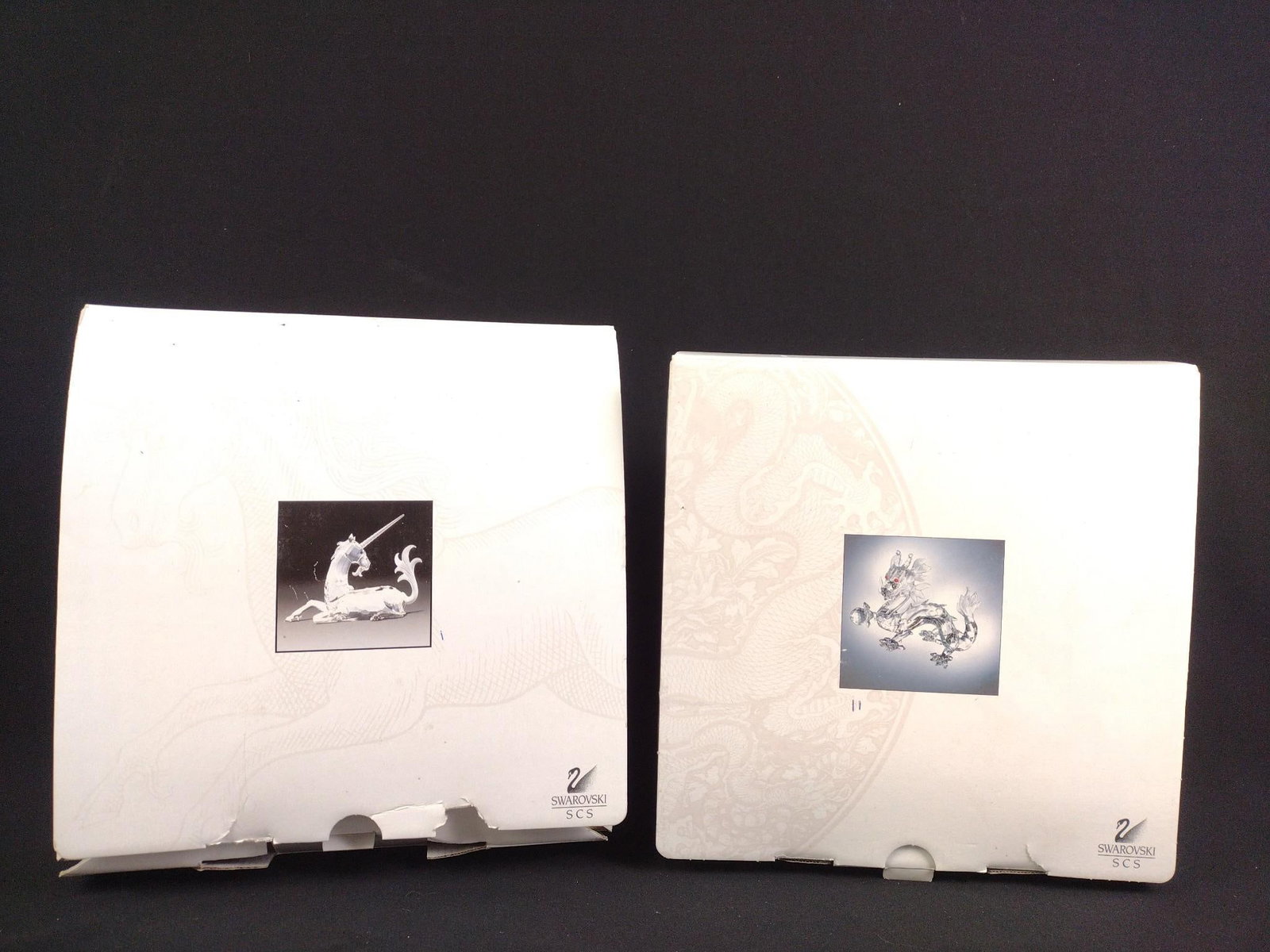 Swarovski Crystal Dragon and Unicorn: A nice collection of Swarovski Crystal collectibles in their original double boxes. Sizes range from 5" to 6". All perfect condition. Foam breaking down in boxes.