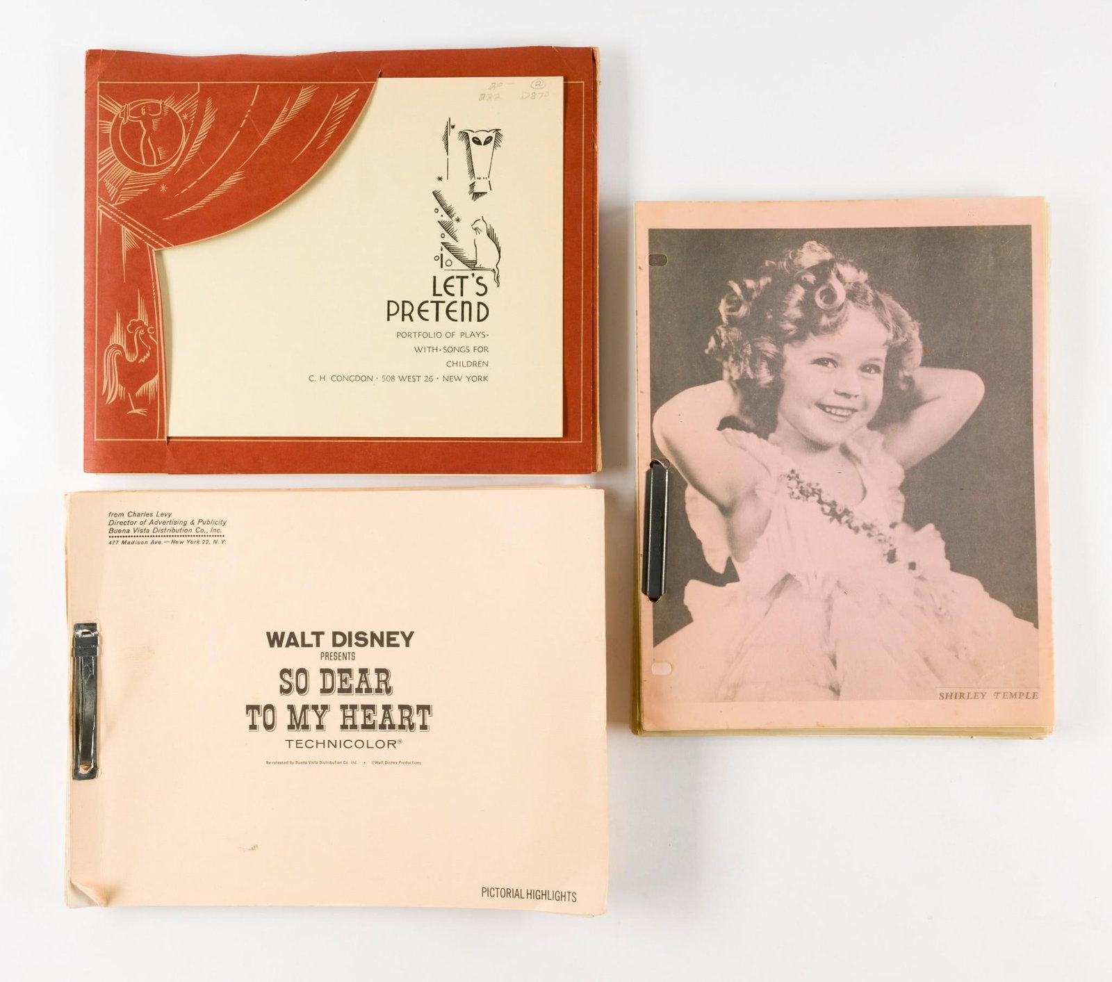 3 Pcs of Celebrity and Walt Disney Ephemera: Includes small binder of Shirley Temple photographs and ephemera, Walt Disney pictorial highlights, and songs for children. All in acceptable condition with normal wear and tear. Due to being in stora