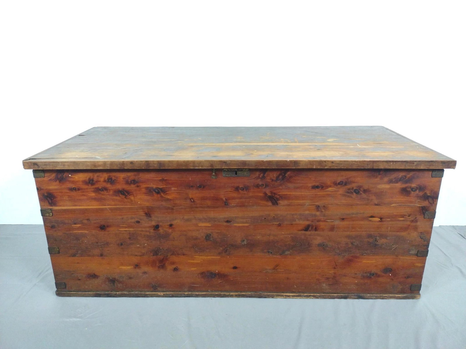 Cedar Chest: 54-1/2" wide X 23-1/4" deep X 21" high. Has scratches and finish loss. MG.