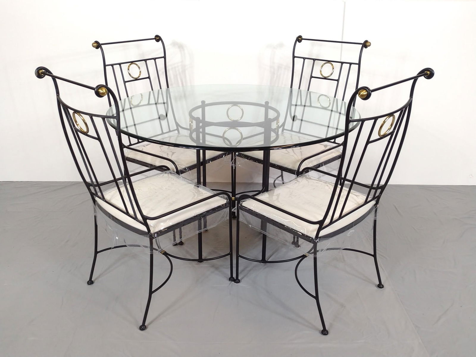 Hearthstone Ent. Inc. Glass Top Table w/ 5 Chairs: Glass top table with metal frame with 5 chairs. Chairs marked Hearthstone Ent. Inc. Table measures 47-1/2" wide x 30" high. Chairs measure 19-1/2" wide x 41" high. MG