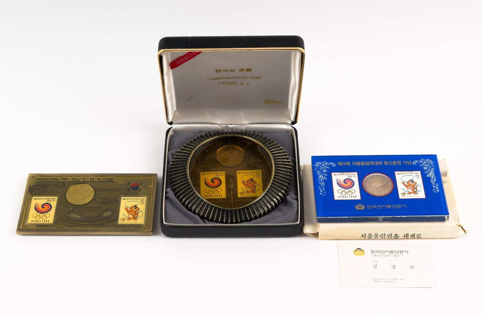 Seoul Olympics 1988 Plaques, Coins, Commemoratives: Three items including a bronze stadium replica with stamps and coins.