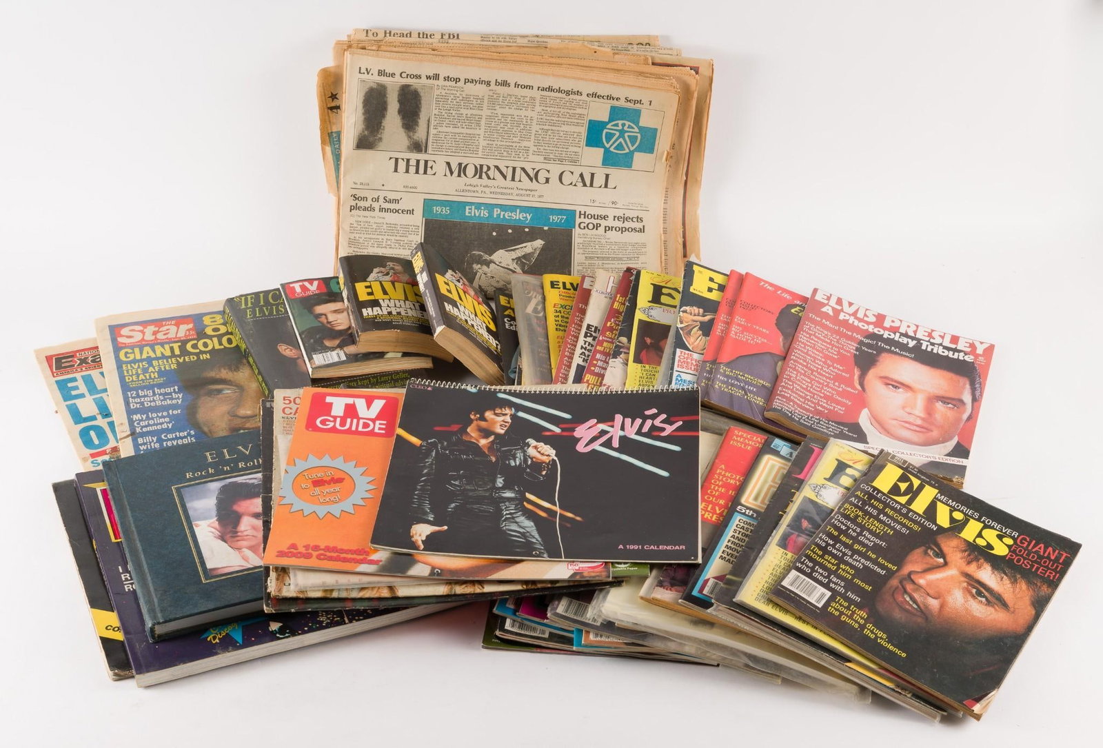 Large Grouping Elvis Ephemera: Includes newspapers, magazines, calendars, record covers (no record), and more. All with wear consistent with age and use. LR