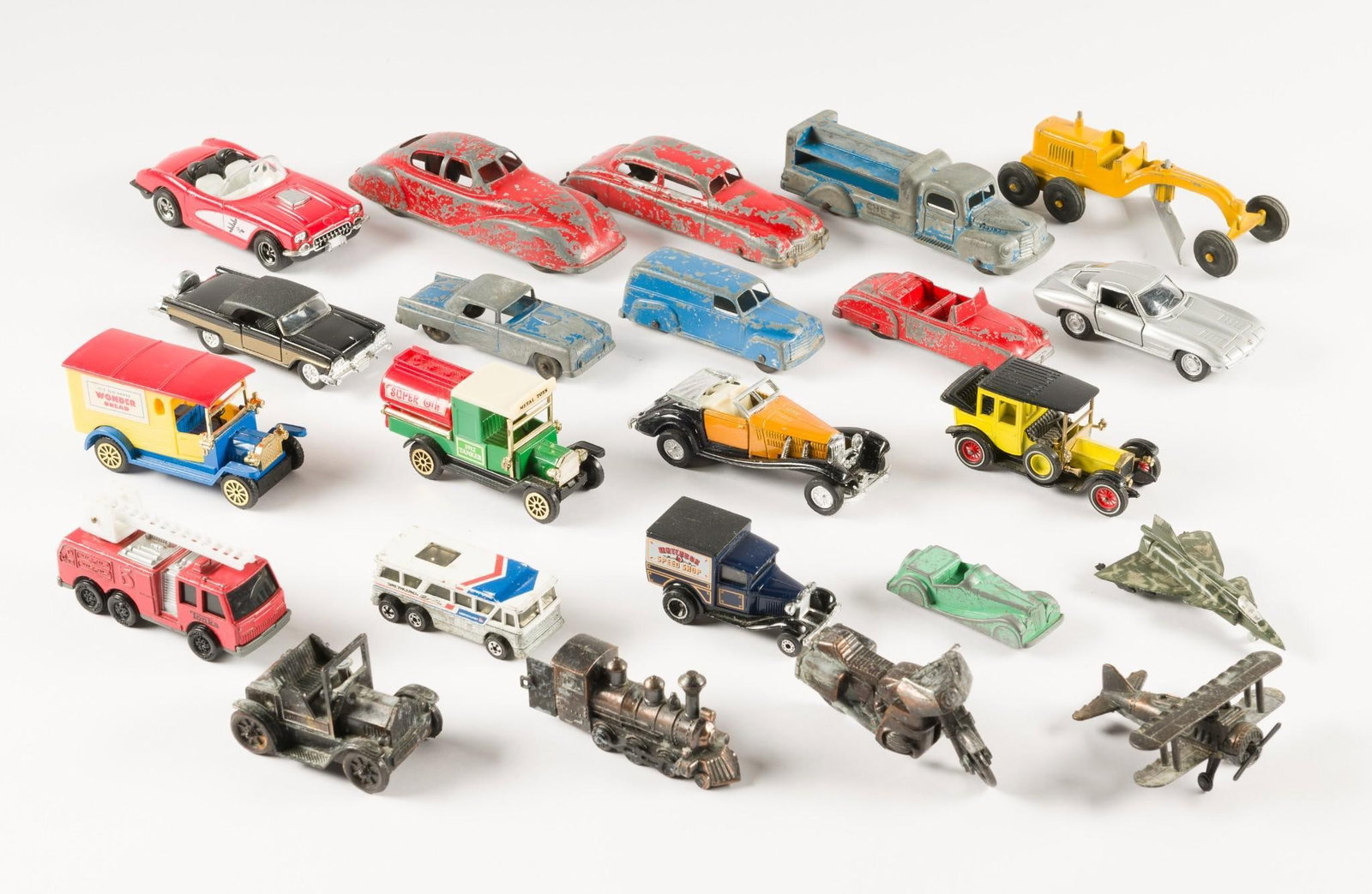 23 Vintage Cars, Trucks, and Planes incl Tootsie Toy: 3" to 6" long. Some paint loss and wear. Sold in as is condition.