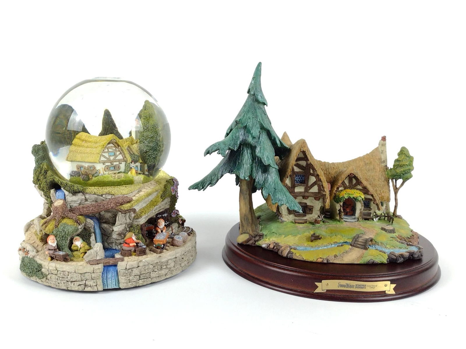 2 - Snow White and 7 Dwarfs Collectibles incl Cottage: NOT ELIGIBLE FOR IN-HOUSE SHIPPING. Includes Seven Dwarfs Cottage with wood stand and "Hi Ho-Hi Ho" snow globe. Snow globe working. Cottage number AN195. 7-1/4" to 8" high.