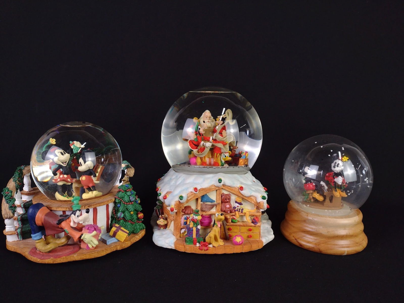3 Christmas Mickey and Friends Snow Globes: NOT ELIGIBLE FOR IN-HOUSE SHIPPING. Includes 1.) "Santa Claus is Coming to Town" Mickey and Goofy with Santa snow globe. Working. 2.) Mickey and Minnie on piano snow globe. Not working and no water. 3