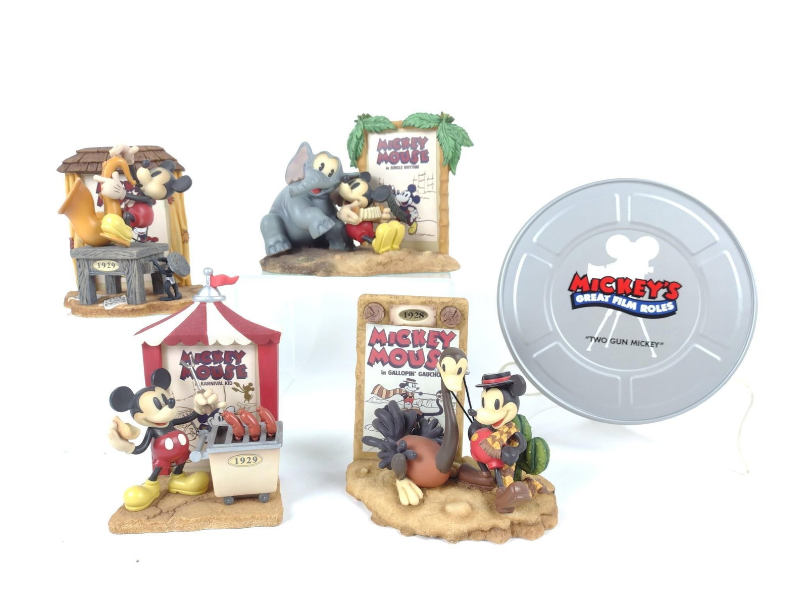 5 Mickey's Great Film Roles Figurines and Tape: Includes 1.) "2 Gun Mickey" black and pen tape tin set. 2.) Includes closed limited edition 480,878 "Mickey's Follies, 1929" 3.) Closed limited edition 314,412 "Gallopin Gaucho, 1928" figurine. 4.) Cl