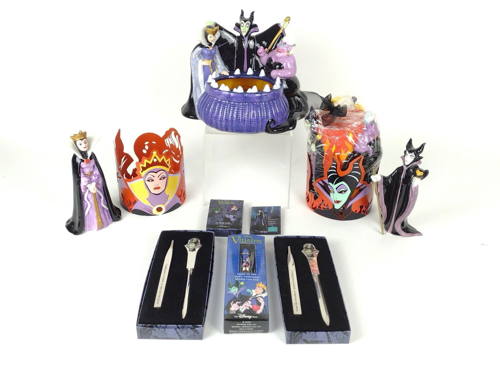9 Disney Villains Collectibles: Includes figurines, candle, desk accessories and more. 7-3/4" to 7-1/2" high. Minor chip to back of figurine with three villains.
