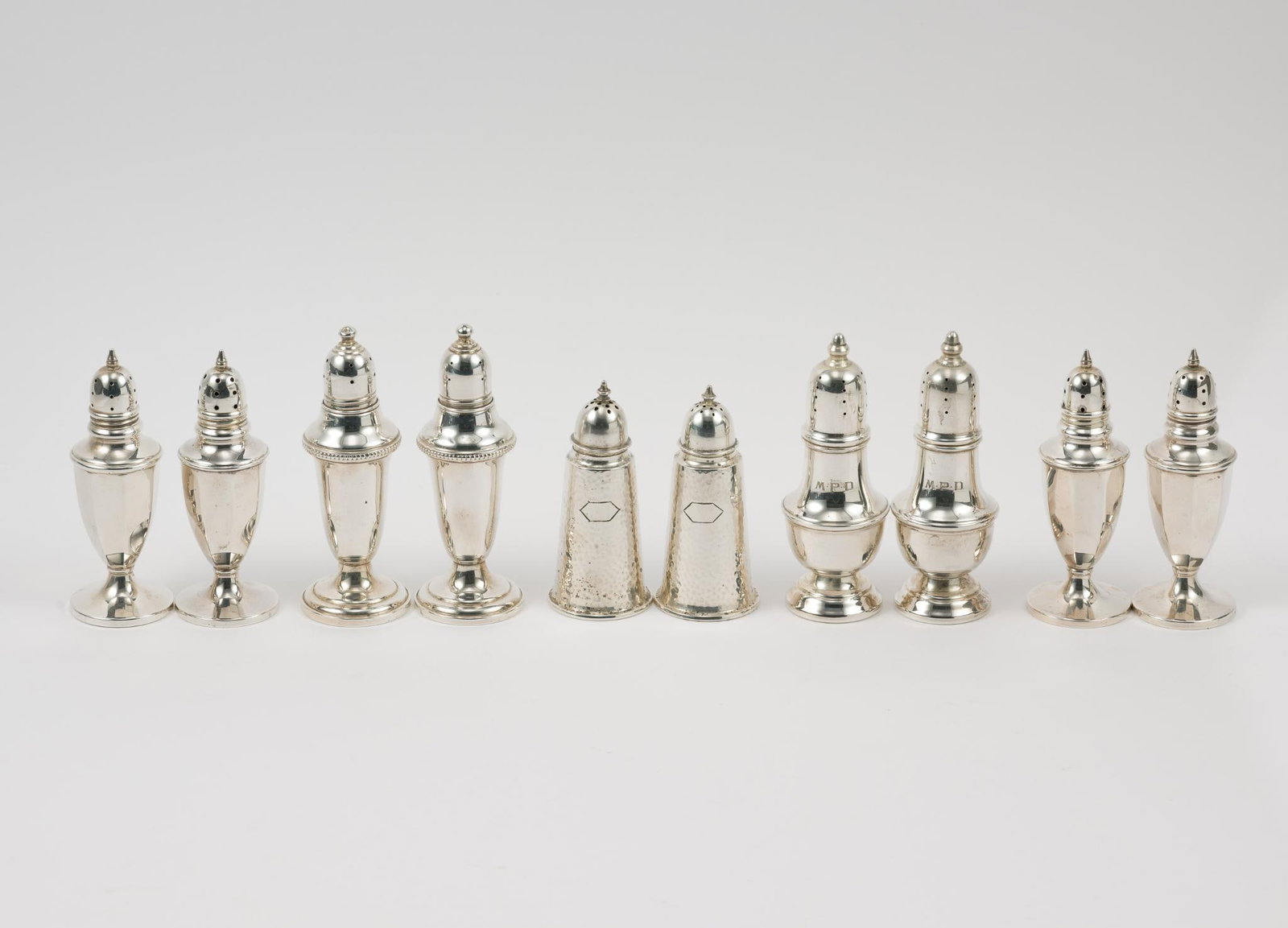 5 Prs. Sterling Silver Salt and Pepper Shakers: Includes Empire, Genova, R. Wallace and Sons, and M. Fred Hirsch Co. 1-5/8" to 1-3/4" diameter x 3-1/2" to 4-1/4" high. 10.94 ozt total.