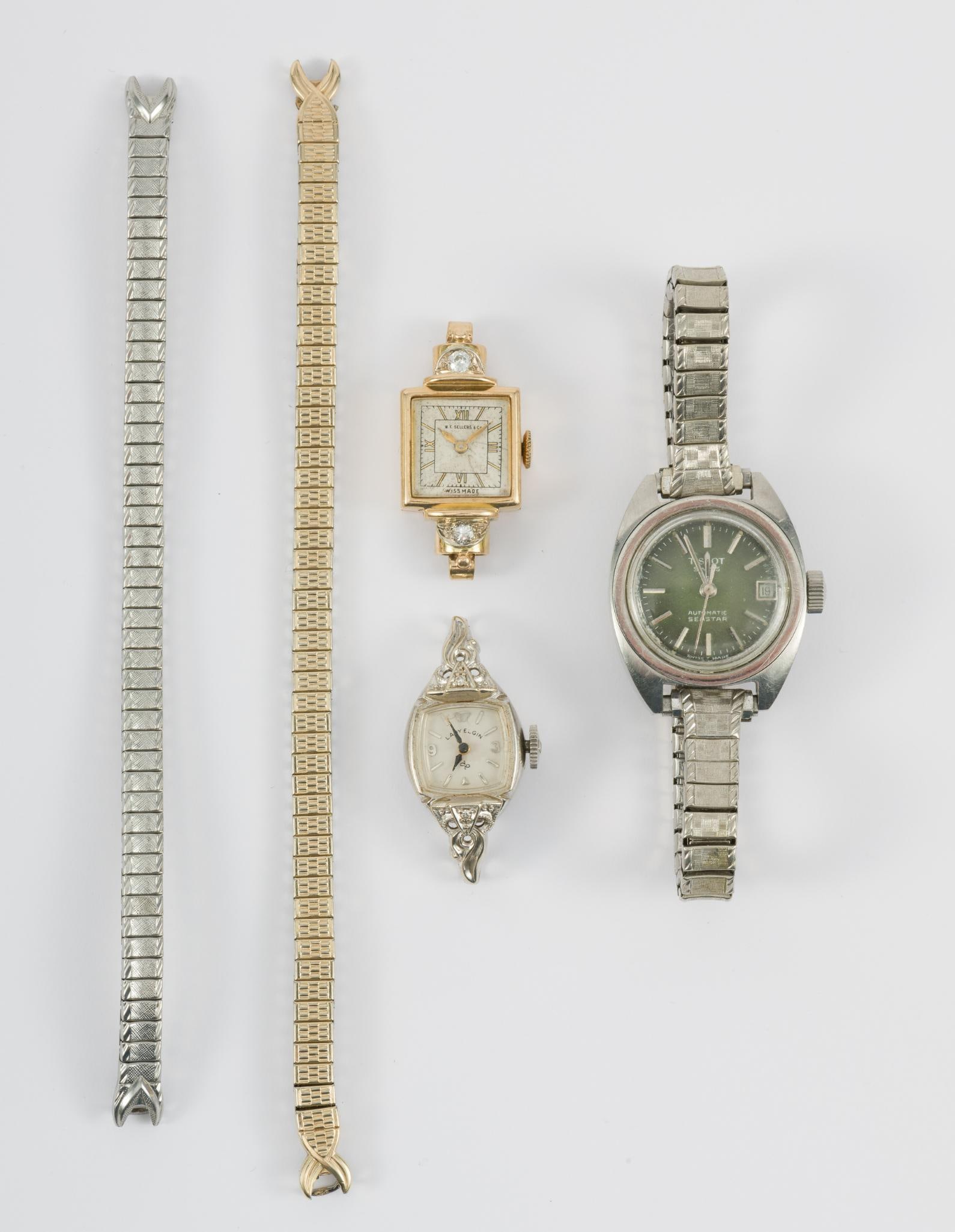 A Group of Antique Gold Women's Watches: (1) 14k yellow gold with two diamonds by W. F. Sellers and Co. This watch is running. Has Speidel flex band. (1) 14k white gold Lady Elgin with Speidel flex band. Not working. (1) Stainless steel Tiss