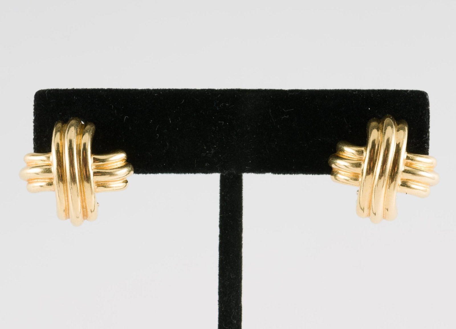 Tiffany and Co 18K Gold Signature X Earrings: 18k gold (marked 750) T and Co. signature X earrings with pierced Omega backs. 13.2 grams. 5/8" wide.