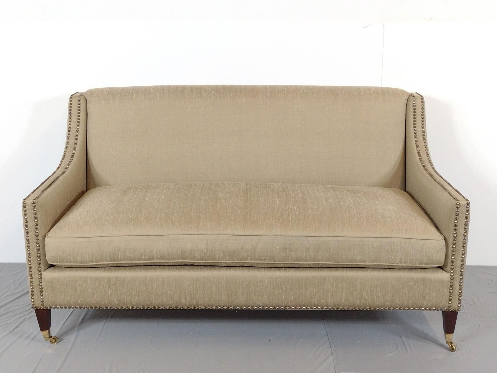 Upholstered Sofa with Studs: NOT ELIGIBLE FOR IN-HOUSE SHIPPING. 65" wide X 33" deep X 35-1/2" high. No manufactures name found.