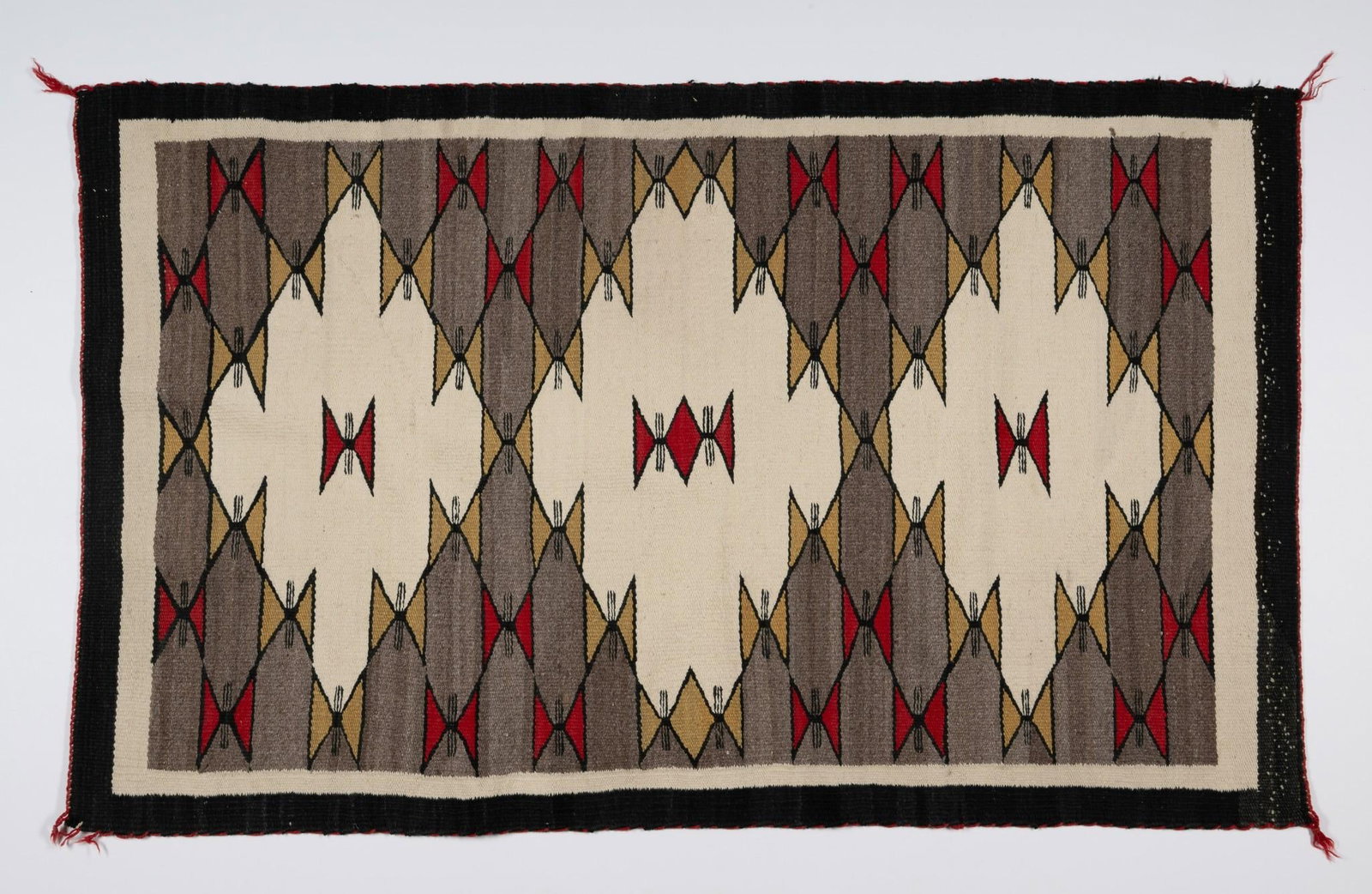 Navajo Eyedazzler Rug: DESCRIPTION: Navajo eyedazzler rug, probably 1980's. Eye dazzler rugs are a style of Navajo rug that developed in the late 19th century. They feature elaborate stair step and stacked diamond designs a