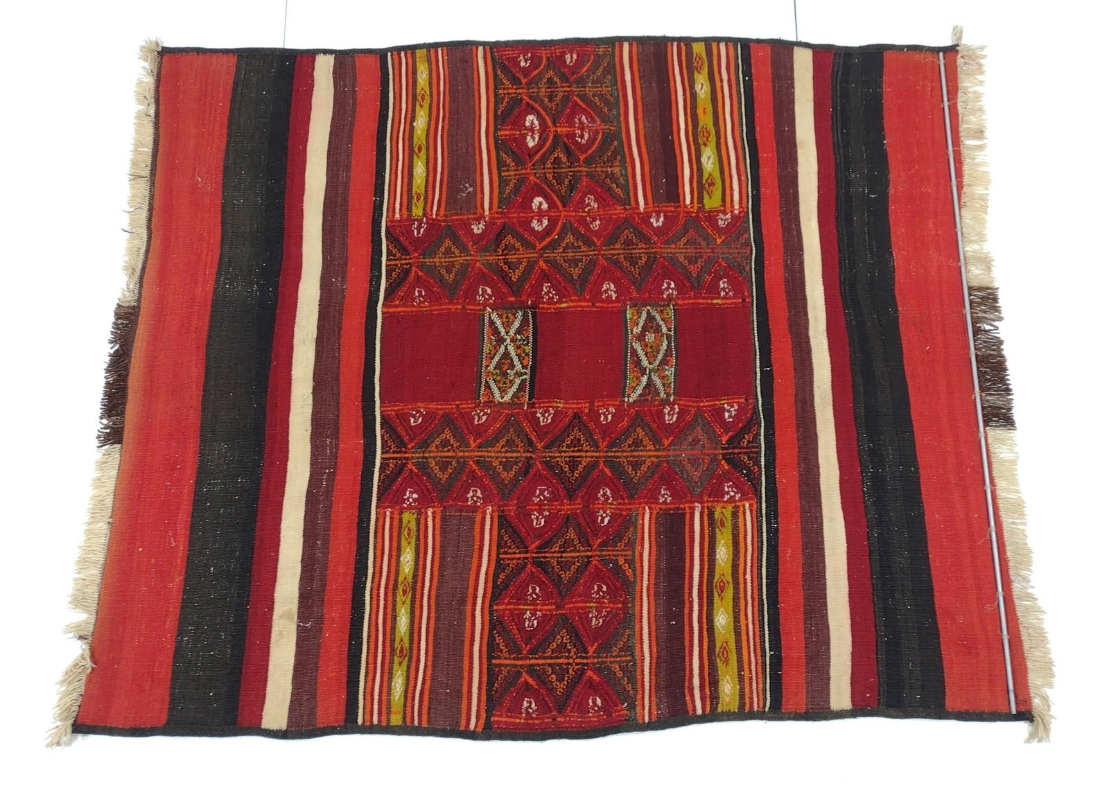 Geometric Area Rug: NOT ELIGIBLE FOR IN-HOUSE SHIPPING. Flatweave. 6'3" long X 5'1" wide. Some stretching. PROVENANCE: From the Estate of James L. Stanfield, Veteran National Geographic photographer (1937-2023). Mr. Stan