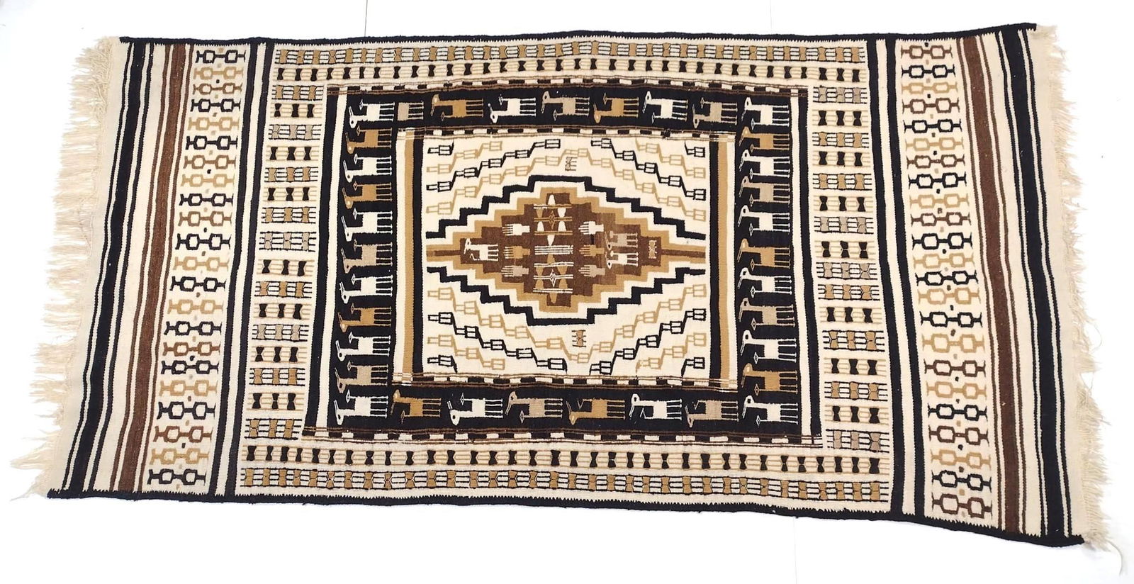 Area Rug with Center Diamond: NOT ELIGIBLE FOR IN-HOUSE SHIPPING. Flatweave. 9' long X 4'6" wide. Some stretching. PROVENANCE: From the Estate of James L. Stanfield, Veteran National Geographic photographer (1937-2023). Mr. Stanfi