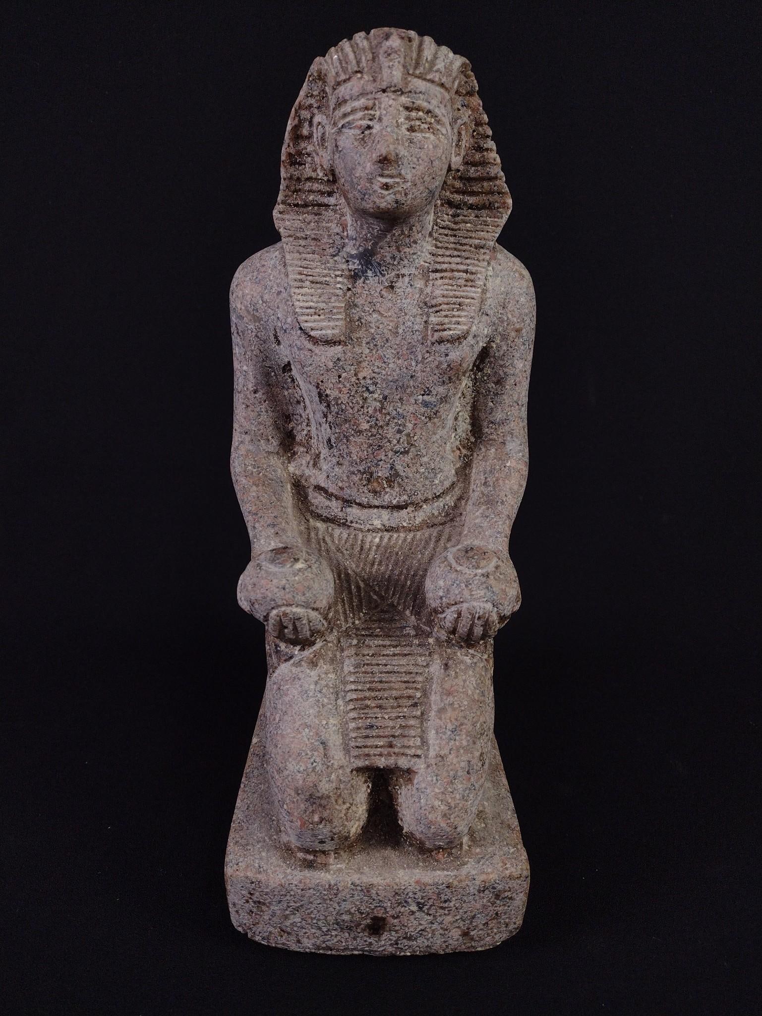King Thutmose III Kneeling Sculpture Offering 2 Vases: Replica sculpture. 4-1/4" wide x 5-3/4" deep x 10-1/2" high. PROVENANCE: From the Estate of James L. Stanfield, Veteran National Geographic photographer (1937-2023). Mr. Stanfield was one of the world