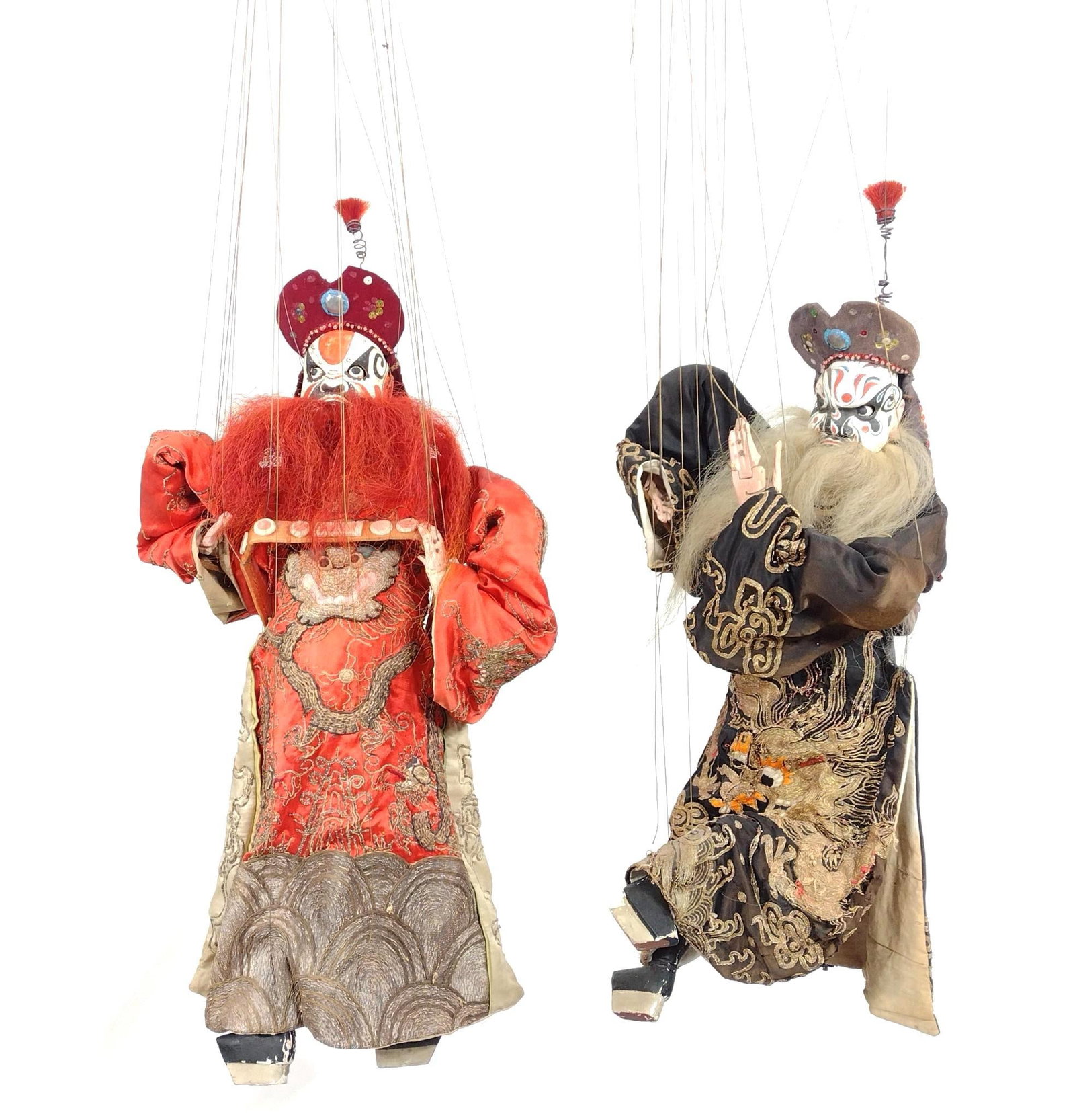 Two Asian String Puppets: Matching wedding robe being offered in lot 160. Black 26” high, 48” overall. Red 27” high, 50” overall. Matching wedding robe from Bhutan. PROVENANCE: From the Estate of James 