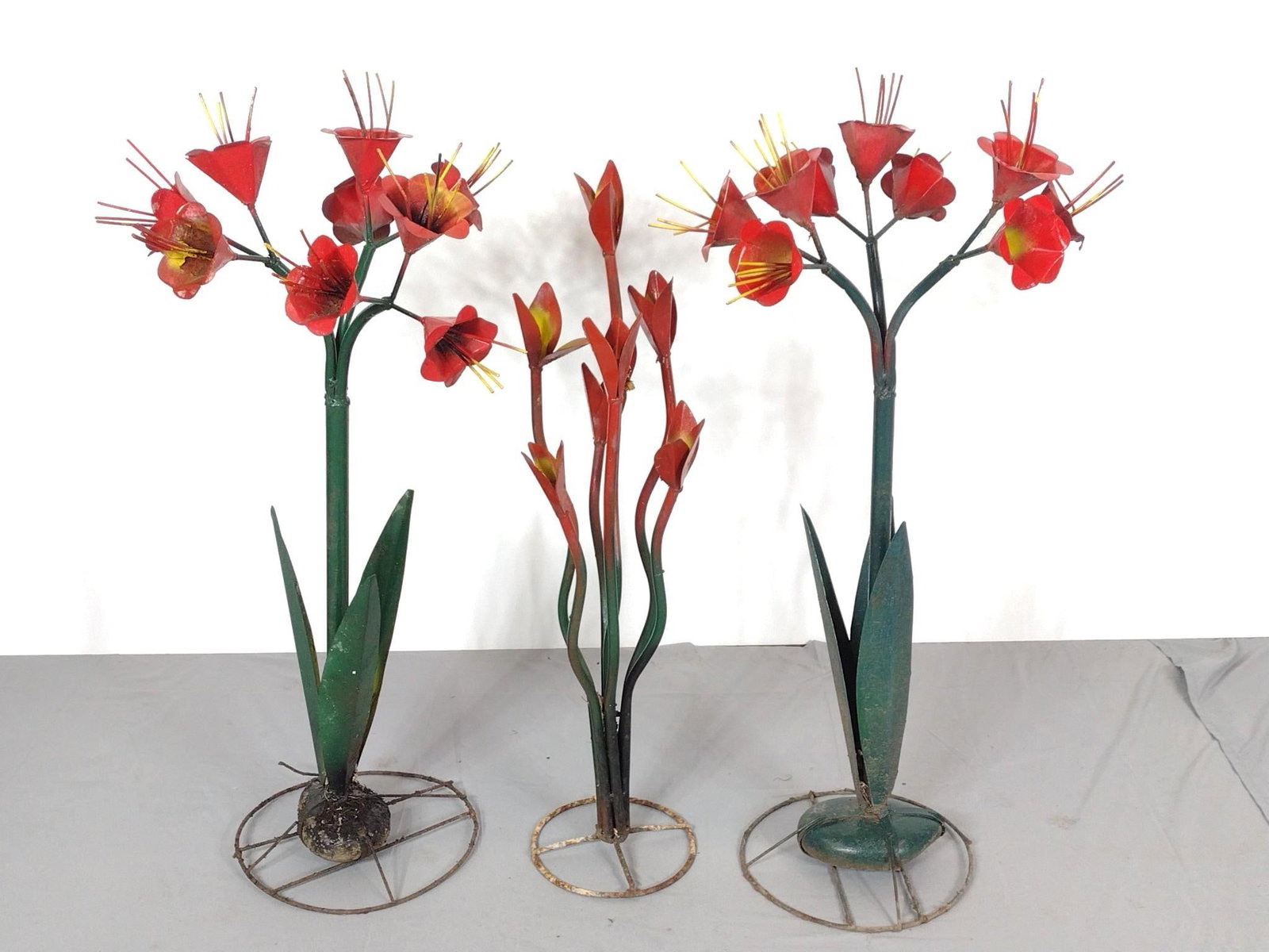 3 Metal Flower Yard Sculptures: NOT ELIGIBLE FOR IN-HOUSE SHIPPING. 34" to 37" high. One flower has repair. PROVENANCE: From the Estate of James L. Stanfield, Veteran National Geographic photographer (1937-2023). Mr. Stanfield was o