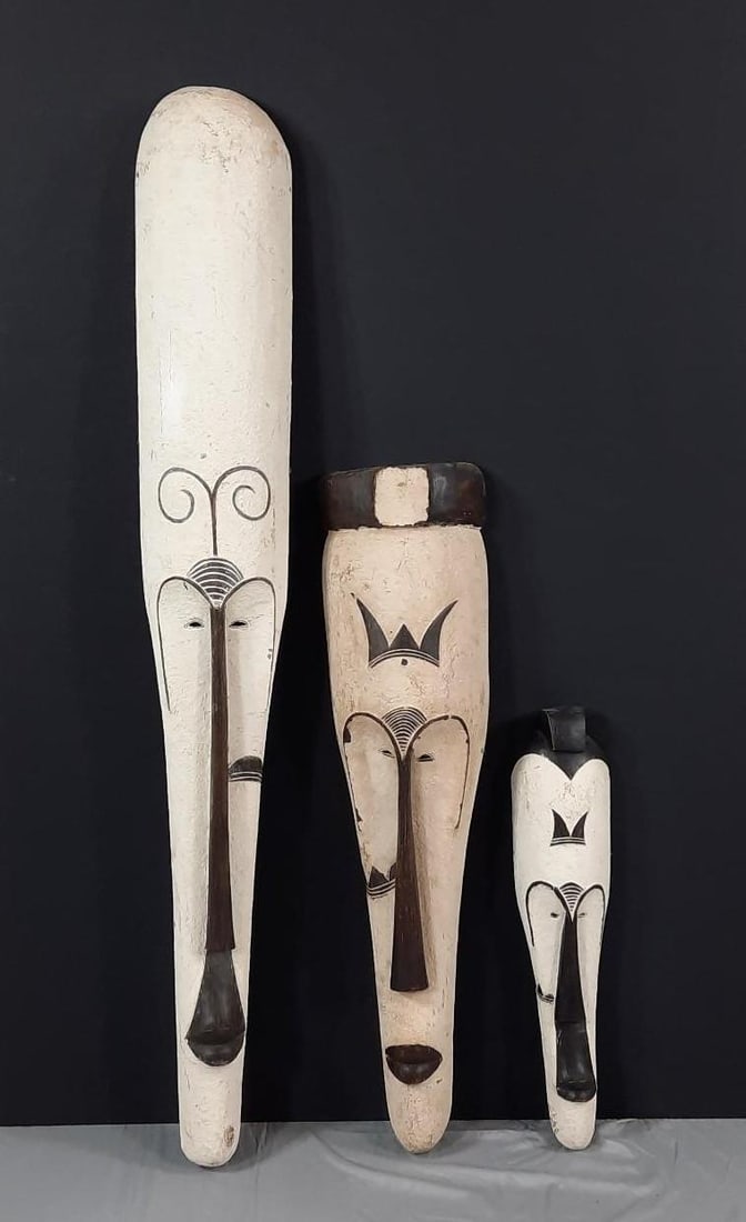 3 Fang Style Wood Masks: NOT ELIGIBLE FOR IN-HOUSE SHIPPING. 6" to 9-1/2" wide x 25" to 60" high. PROVENANCE: From the Estate of James L. Stanfield, Veteran National Geographic photographer (1937-2023). Mr. Stanfield was one 