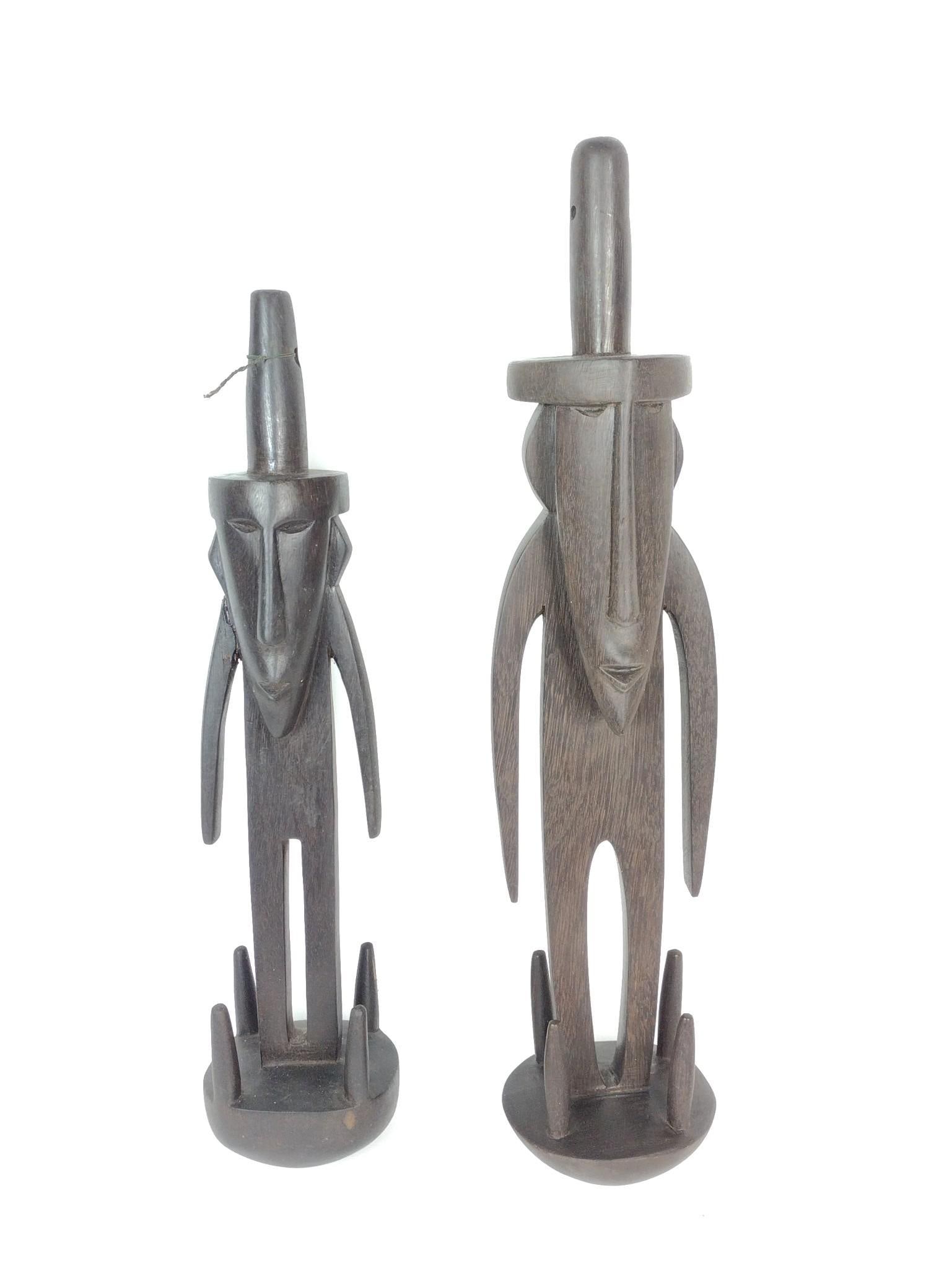 2 Ethnographic Figural Wood Carvings: 4" to 4-1/2" wide x 18" to 20-1/2" high. Smaller with repair to one arm. PROVENANCE: From the Estate of James L. Stanfield, Veteran National Geographic photographer (1937-2023). Mr. Stanfield was one 
