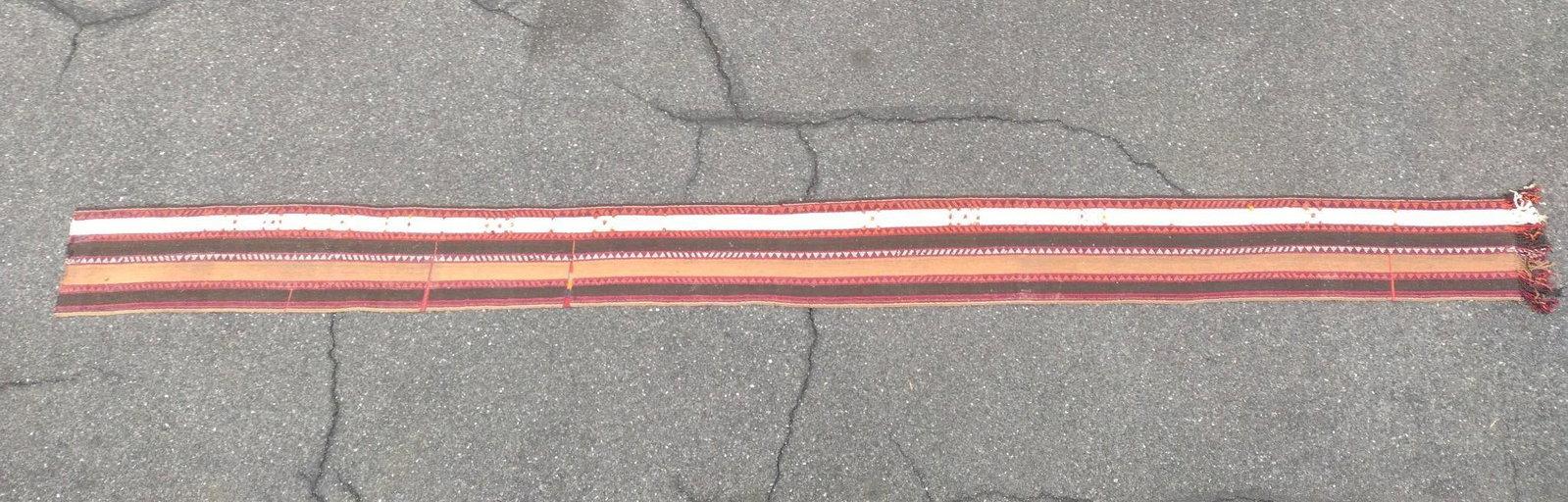 22' Tribal Runner: Flatweave. 1'6" wide x 22'2" long. Some wear consistent with age and use. Fringe on one end. Some discoloration. PROVENANCE: From the Estate of James L. Stanfield, Veteran National Geographic photogra