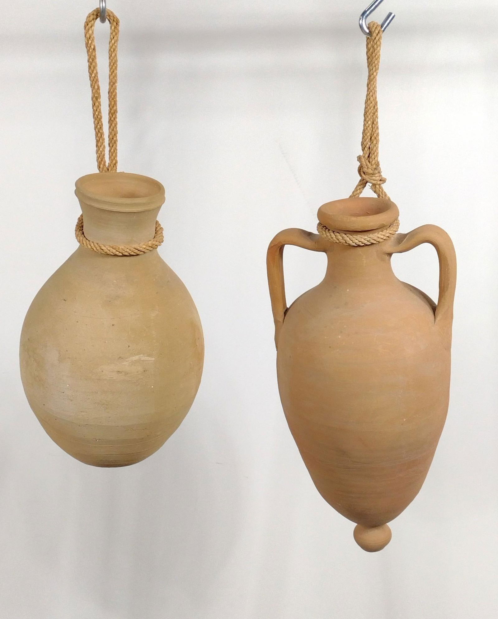 2 Amphora Jars: NOT ELIGIBLE FOR IN-HOUSE SHIPPING. 9" to 9-1/2" diameter x 16" to 21" high. PROVENANCE: From the Estate of James L. Stanfield, Veteran National Geographic photographer (1937-2023). Mr. Stanfield was