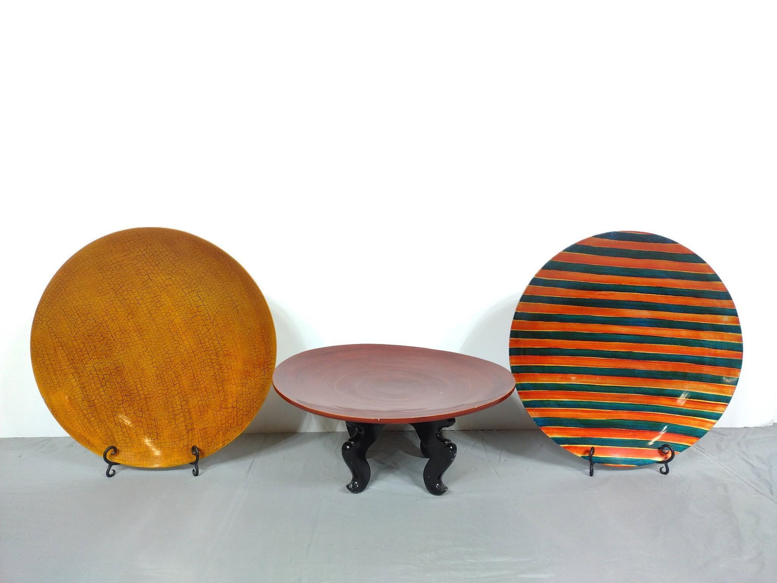 3 Decorative Chargers: NOT ELIGIBLE FOR IN-HOUSE SHIPPING. Each includes plate stand. 22" diameter. PROVENANCE: From the Estate of James L. Stanfield, Veteran National Geographic photographer (1937-2023). Mr. Stanfield was 